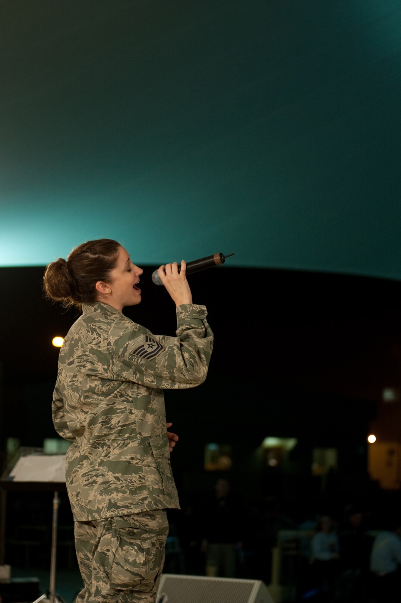 Tech. Sgt. Christin Foley, AFCENT Band Sirocco vocalist, performs for an audience of deployed servicemembers in Southwest Asia, Dec. 9, 2009. Sirocco is deployed from Lackland Air Force Base, Texas, and performed throughout Southwest Asia to positively promote troop morale, and diplomacy and outreach to host nation communities. (U.S. Air Force Photo/ Staff Sgt. Robert Barney) 