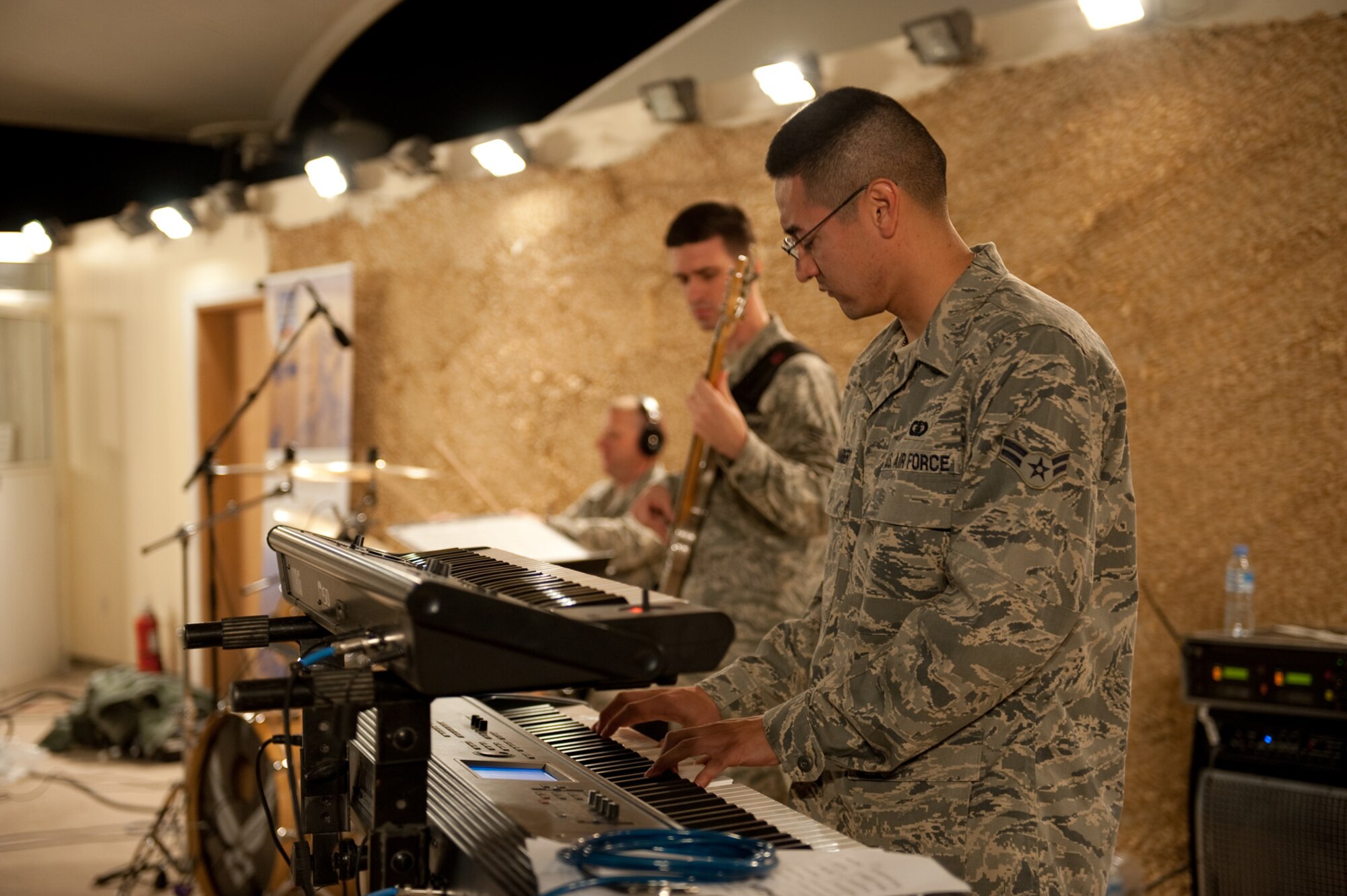 Airman 1st Class Dennis Lambert, AFCENT Band Sirocco keyboardist, performs for an audience of deployed servicemembers in Southwest Asia, Dec. 9, 2009. Sirocco is deployed from Lackland Air Force Base, Texas, and performed throughout Southwest Asia to positively promote troop morale, and diplomacy and outreach to host nation communities. (U.S. Air Force Photo/ Staff Sgt. Robert Barney) 