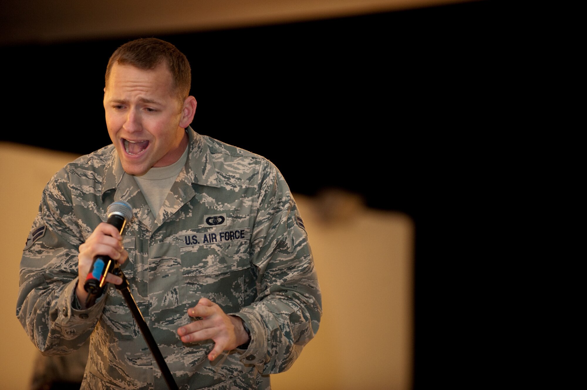 Airman 1st Class Clayton Lee, AFCENT Band Sirocco vocalist, performs for an audience of deployed servicemembers in Southwest Asia, Dec. 9, 2009. Sirocco is deployed from Lackland Air Force Base, Texas, and performed throughout Southwest Asia to positively promote troop morale, and diplomacy and outreach to host nation communities. (U.S. Air Force Photo/ Staff Sgt. Robert Barney) 