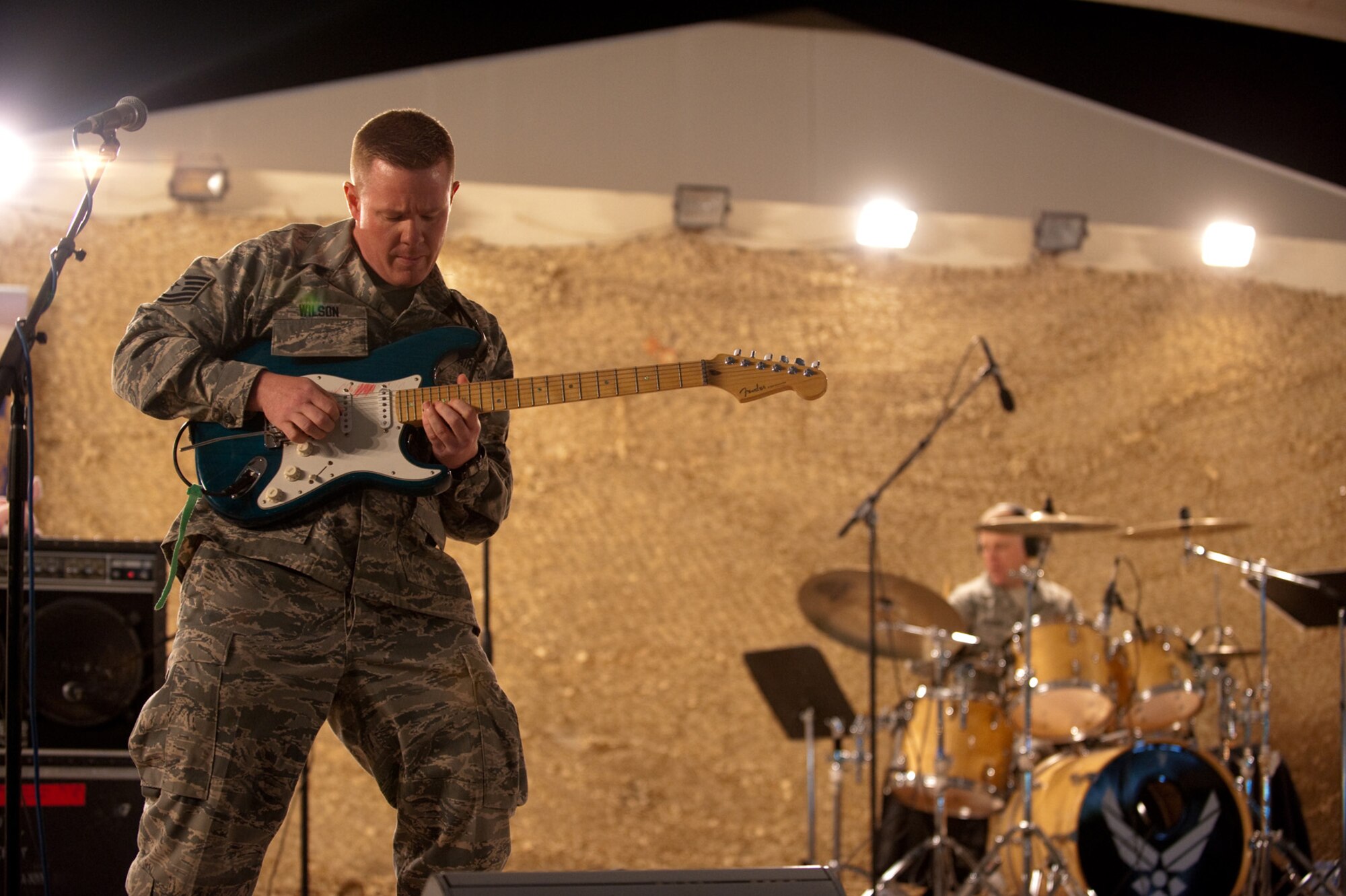 Tech. Sgt. Steven Wilson, AFCENT Band Sirocco guitarist, performs for an audience of deployed servicemembers in Southwest Asia, Dec. 9, 2009. Sirocco is deployed from Lackland Air Force Base, Texas, and performed throughout Southwest Asia to positively promote troop morale, and diplomacy and outreach to host nation communities. (U.S. Air Force Photo/ Staff Sgt. Robert Barney) 