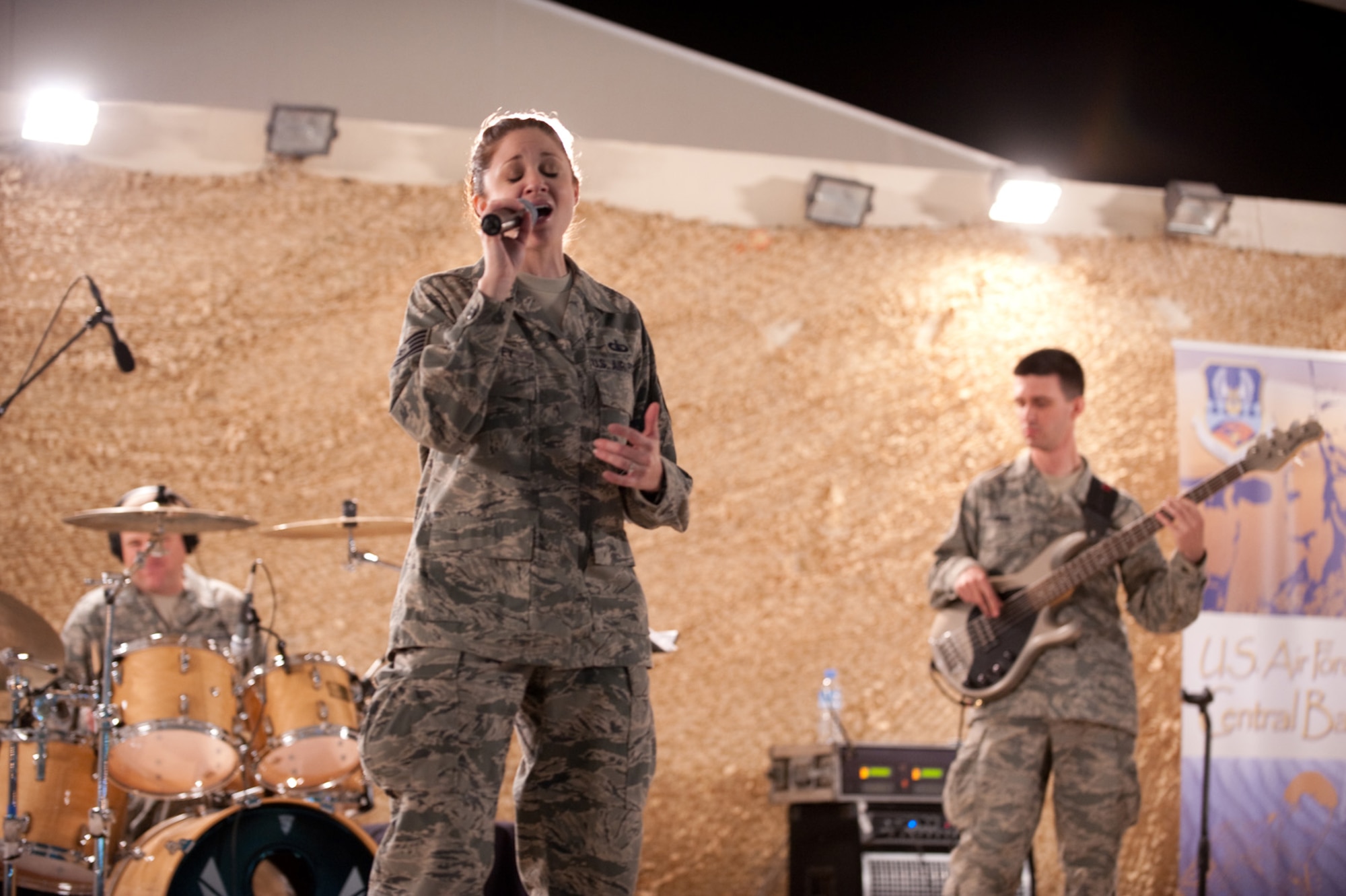 Tech. Sgt. Christin Foley, AFCENT Band Sirocco vocalist, performs for an audience of deployed servicemembers in Southwest Asia, Dec. 9, 2009. Sirocco is deployed from Lackland Air Force Base, Texas, and performed throughout Southwest Asia to positively promote troop morale, and diplomacy and outreach to host nation communities. (U.S. Air Force Photo/ Staff Sgt. Robert Barney) 