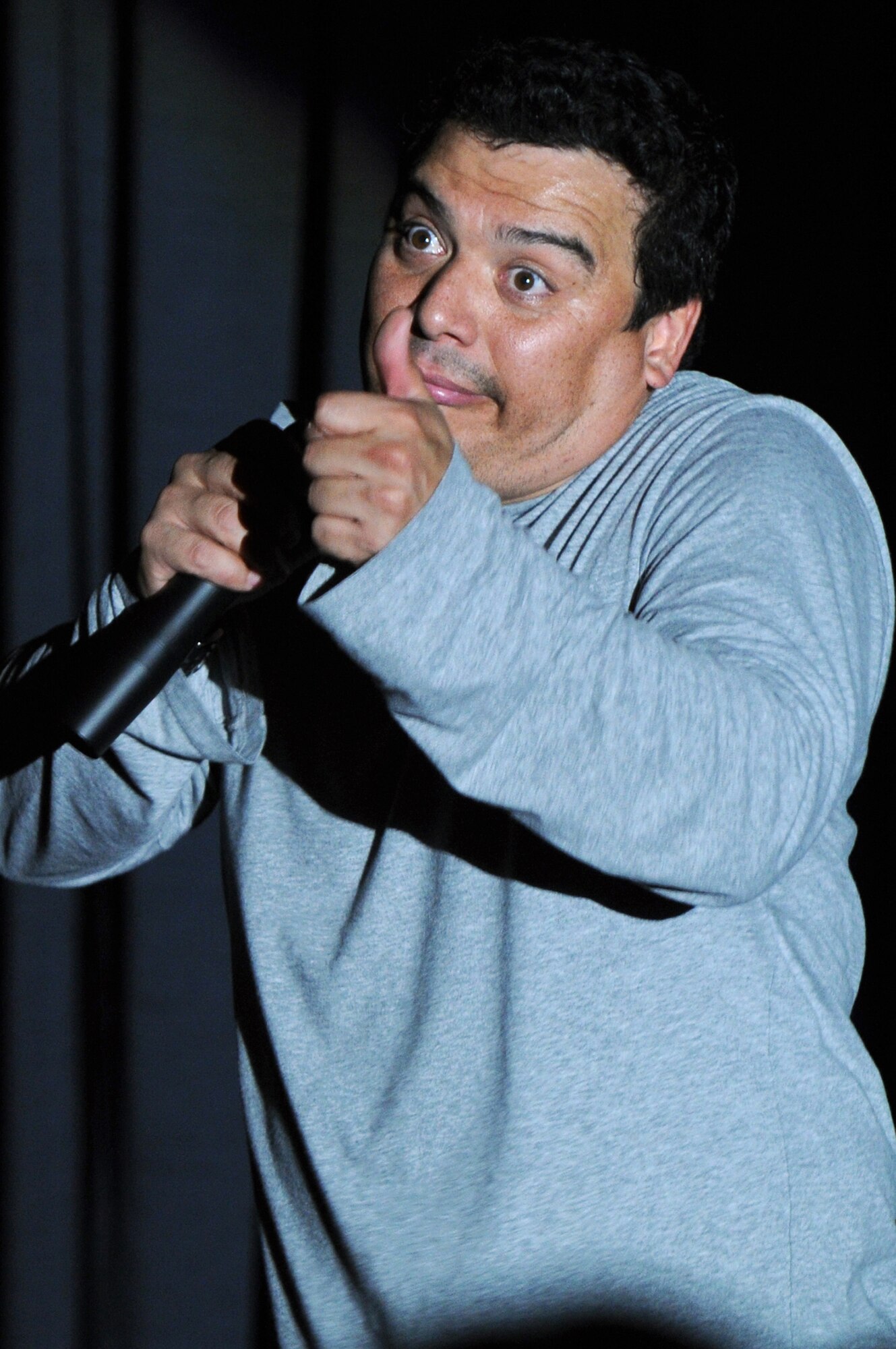 Comedian Carlos Mencia, known for his show "Mind of Mencia," performs an adult stand-up comedy routine for more than 250 people at the Officer's Club, Dec. 9, 2009, Ramstein Air Base, Germany.  Mr. Mencia is part of Tour for the Troops 2009, traveling to overseas bases and entertaining servicemembers and their families.  (U.S. Air Force photo by Tech. Sgt. Chenzira Mallory)