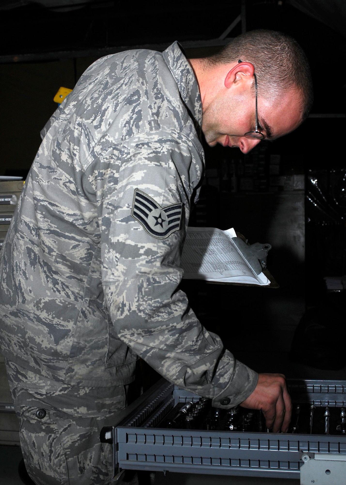 BAGRAM AIRFIELD, Afghanistan -- Staff Sgt. Jonathan Field, a technical order distribution official from 455th Expeditionary Aircraft Maintenance Squadron, inventories the tools of a tool box so it can be issued to an Airman Dec. 10, 2009.  The maintenance Airmen must account for all of their gear before checking it out and returning it, because each tool is necessary for their mission.  Sergeant Field is deployed from Shaw Air Force Base, S.C., and hails from Port St. Lucy, Fla.  (U.S. Air Force photo/Senior Airman Felicia Juenke)