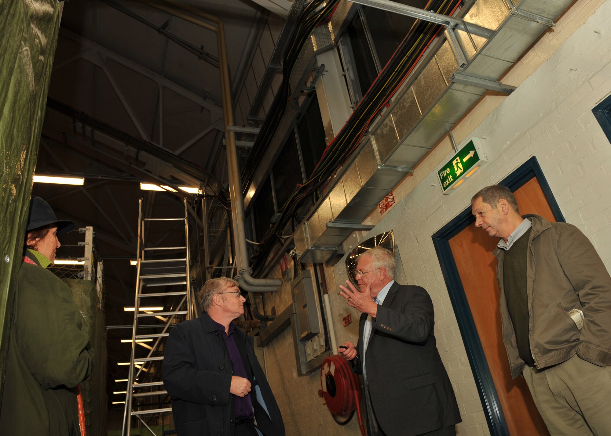 Ken Ellis, Editor of FLYPAST Magazine, a leading UK aviation journal listens as JAC Historian Peter Park describes the accidential bombing of a hangar at Molesworth by the RAF on July 4th 1944.  The hole made by the small inert practice bomb is preserved today.  (U.S. Air Force photo by Staff Sgt. Javier Cruz)