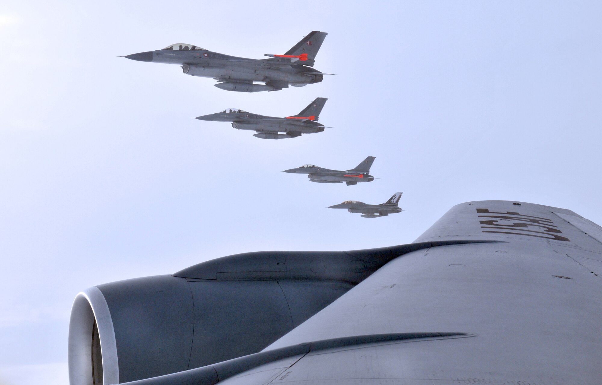 Four Royal Danish Air Force F-16 Fighting Falcons fly in formation off the wing of a KC-135 Stratotanker during a refueling mission over their homeland Dec. 8. In all, the RAF Mildenhall-based Stratotanker refueled 30 aircraft and pumped more than 40,000 tons of fuel. (U.S. Air Force photo/Tech. Sgt. Kevin Wallace)