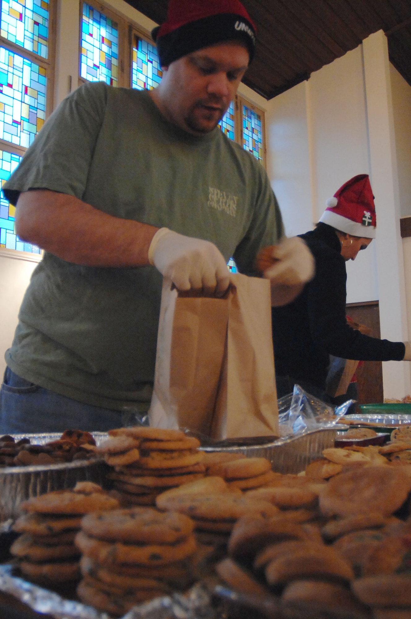 Ramstein Officer Spouses Club member Mike Clark fills bags with cookies destined for single servicemembers living in the dormitories on Vogelweh and Ramstein Air Base, Dec. 10, 2009. The Ramstein Officer Spouses Club together with the Kaiserslautern Spouses Association and the Ramstein Enlisted Spouses Association collected more than 12,000 cookies to give to the more than 11,000 Airman who live in the dorms at the bases. (U.S. Air Force photo by Tech. Sgt. Michael Voss)
 