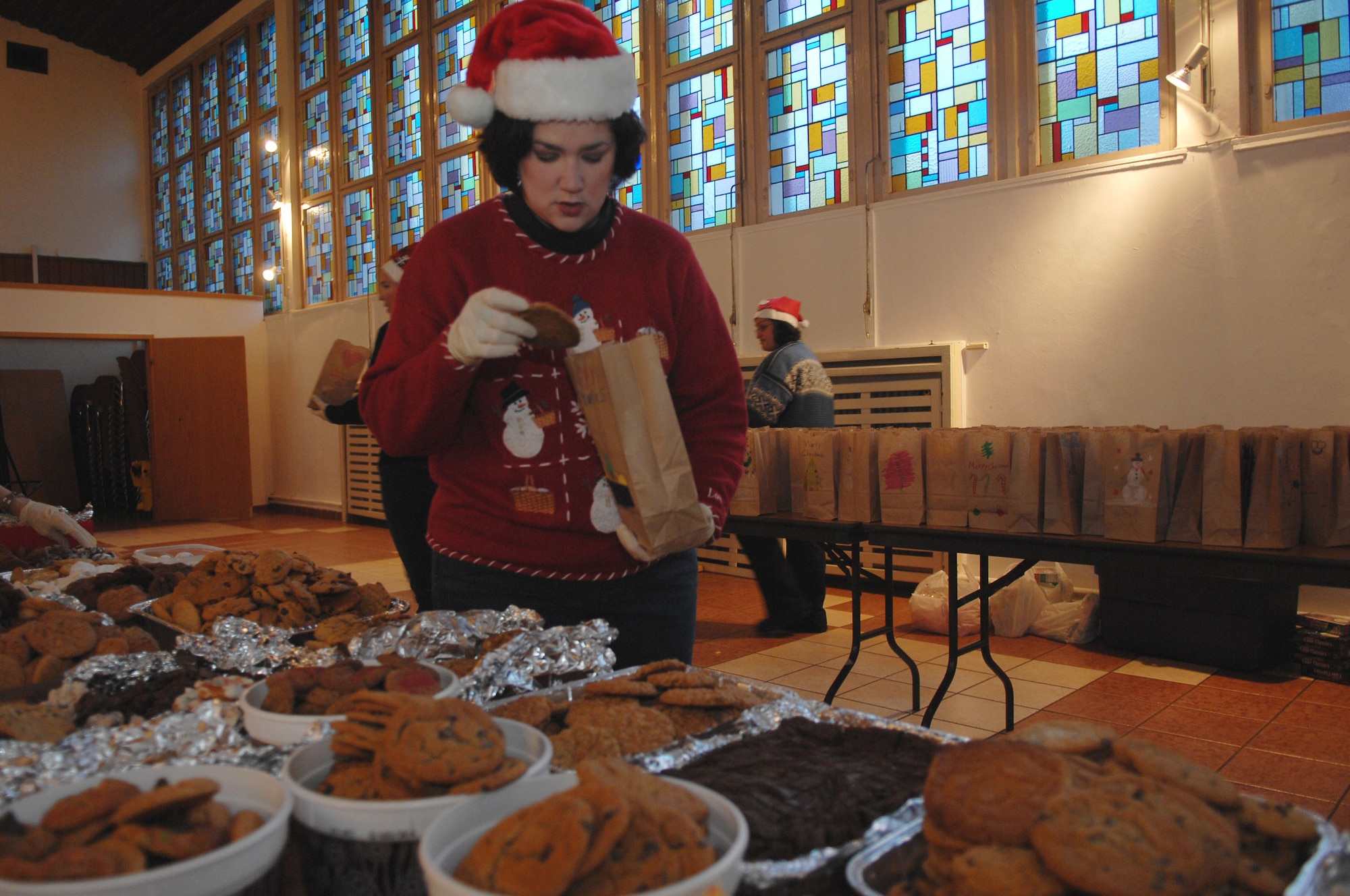 Ramstein Officer Spouses Club President Andy Cobb fills bags with cookies destined for single servicemembers living in the dormitories on Vogelweh Military Complex and Ramstein Air Base, Dec. 10, 2009. The Ramstein Officer Spouses Club together with the Kaiserslautern Spouses Association and the Ramstein Enlisted Spouses Association collected more than 12,000 cookies to give to the more than 11,000 Airman who live in the dorms at the bases. (U.S. Air Force photo by Tech. Sgt. Michael Voss)
 