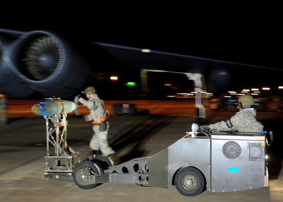 A group of weapons loaders transport a weapon to be loaded in the bomb bay of a B-52 at Base X, a simulated forward operating location, during Barksdale’s conventional readiness inspection Dec. 8.  (U.S. Air Force photo by Staff Sgt. Sarah E. Stegman)(RELEASED)