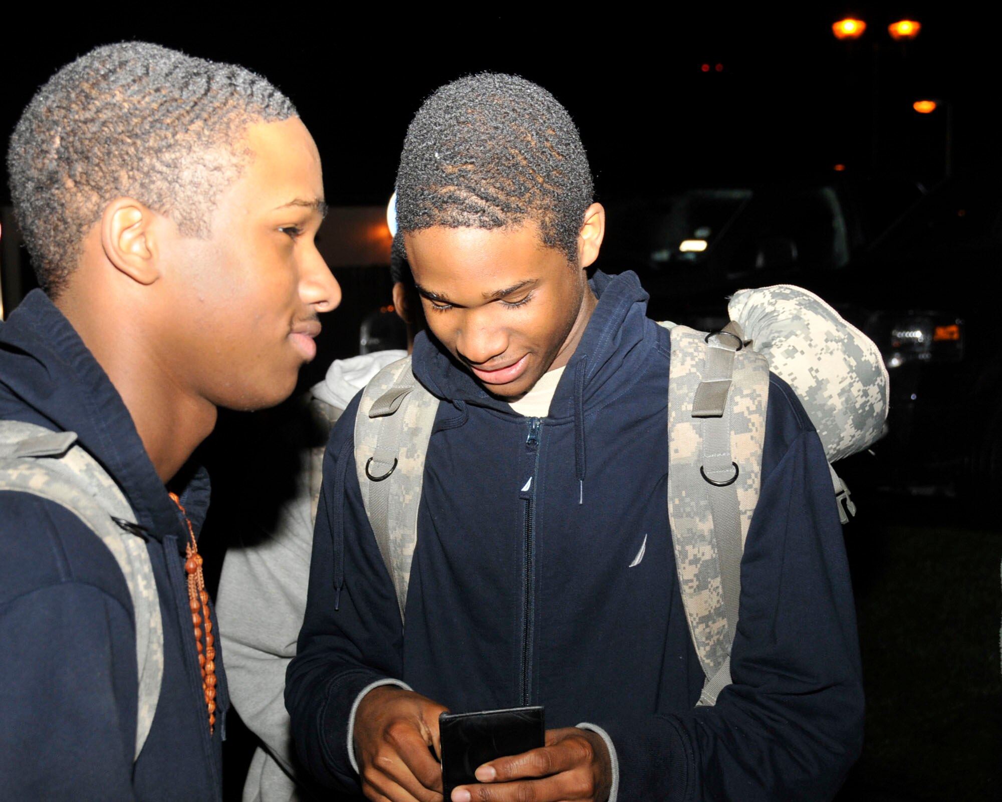 Airmen Dewight Goforth and Dewayne Goforth, 48th Security Forces Squadron members, wait to load the bus to deploy to Southwest Asia at RAF Lakenheath, England, Dec. 9. The identical twin brothers will be deployed together with approximately 40 other security forces team members to Southwest Asia.  (U.S. Air Force photo/Airman 1st Class Eboni Knox)
