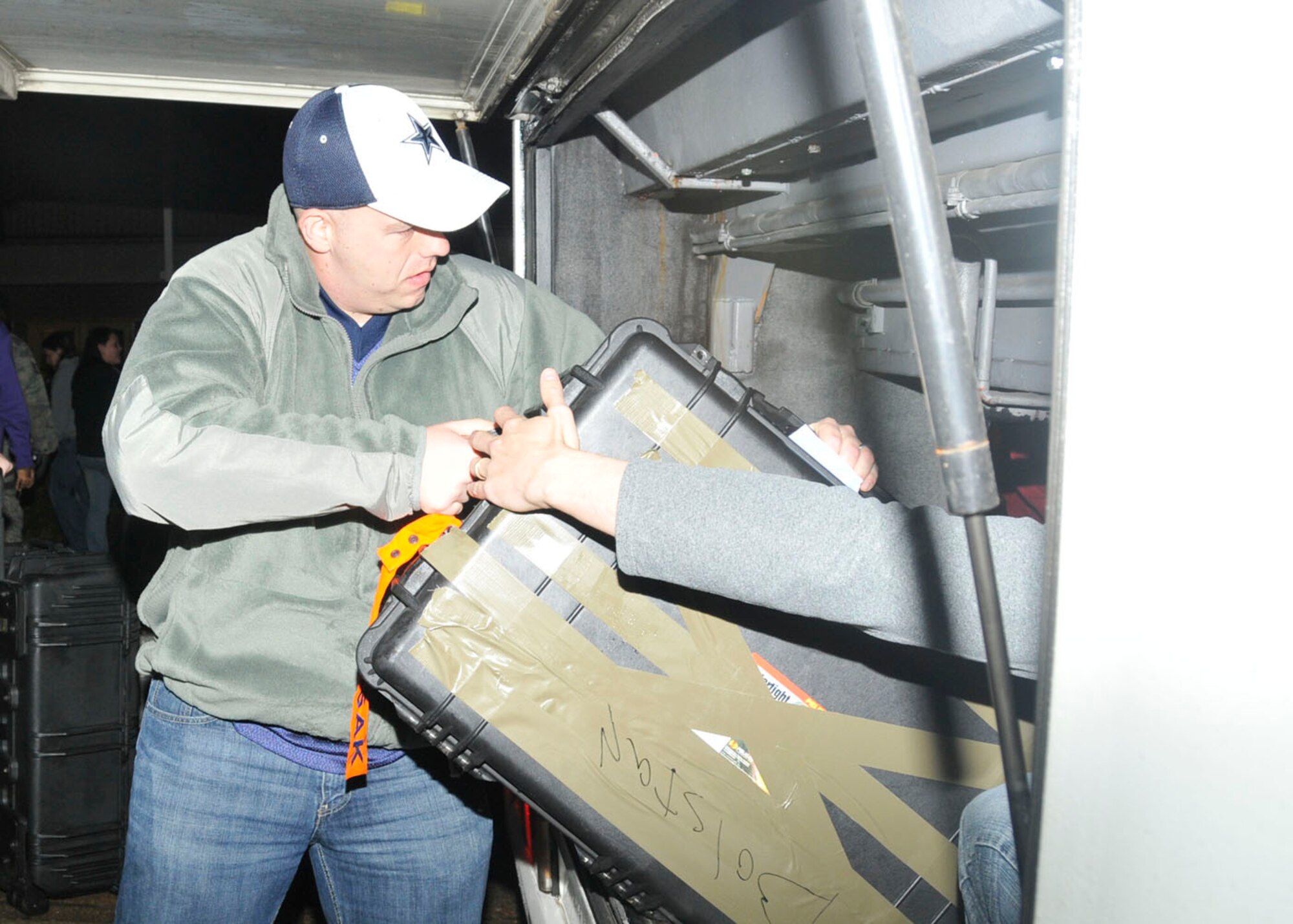Staff Sgt. Seth Bolstad, 48th Security Forces Squadron member, loads his deployment case into the coach before saying goodbye to friends at RAF Lakenheath, England, Dec. 9. Sergeant Bolstad is part of a team leaving to Southwest Asia. (U.S. Air Force photo/Airman 1st Class Eboni Knox)