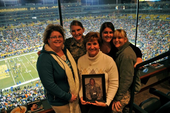 The Green Bay Packers honored military families during their recent Monday Night Football game against the Baltimore Ravens. The Murray family was recognized at half-time on the 50-yard line at Lambeau Field and was surprised by a personal message from Lt. Col. David Murray, a nurse practitioner with the 115th Medical Group deployed to Balad Air Base, Iraq as a flight commander of the intermediate care ward at the Balad Theatre Hospital. Theresa Murray holds a picture of her husband, David and attended the game with her four daughters (left to right) Jennifer Murray-Alston, Staff Sgt. Jamie Murray, Kelly McMeans and Staff Sgt Julie Murray who are all combat veterans, two of which are current members of the 115th FW. (U.S. Air Force photo by Tech. Sgt. Don Nelson)