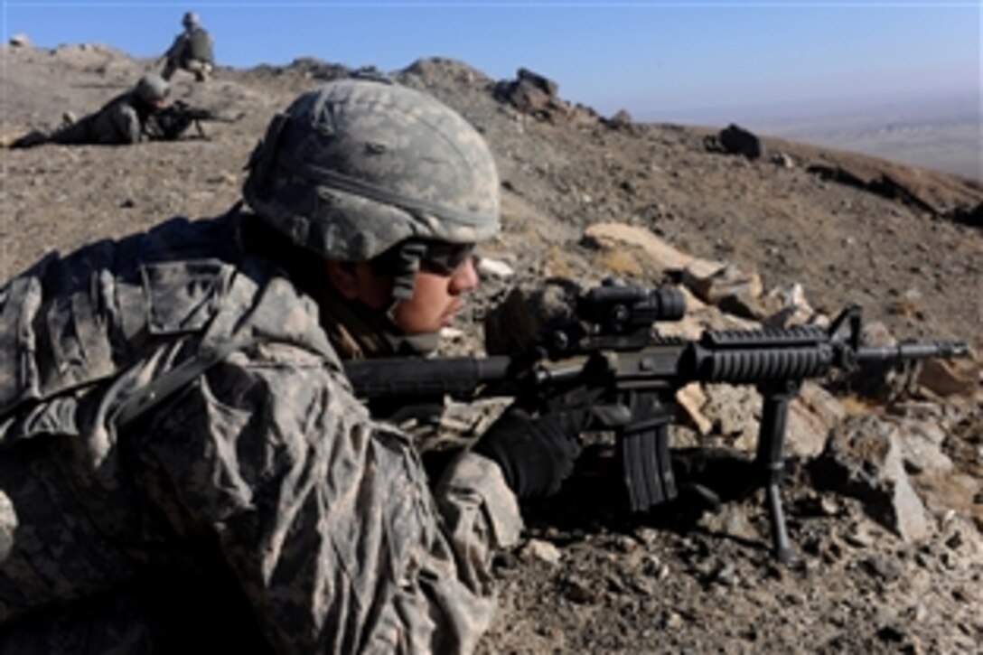 U.S Army Spc. Hermes Rodriguez provides over watch security during 9-line training with Polish medics and Special Forces along with U.S. Army personnel on the side of a mountain inside Ghazni Province, Afghanistan, Dec. 7, 2009.