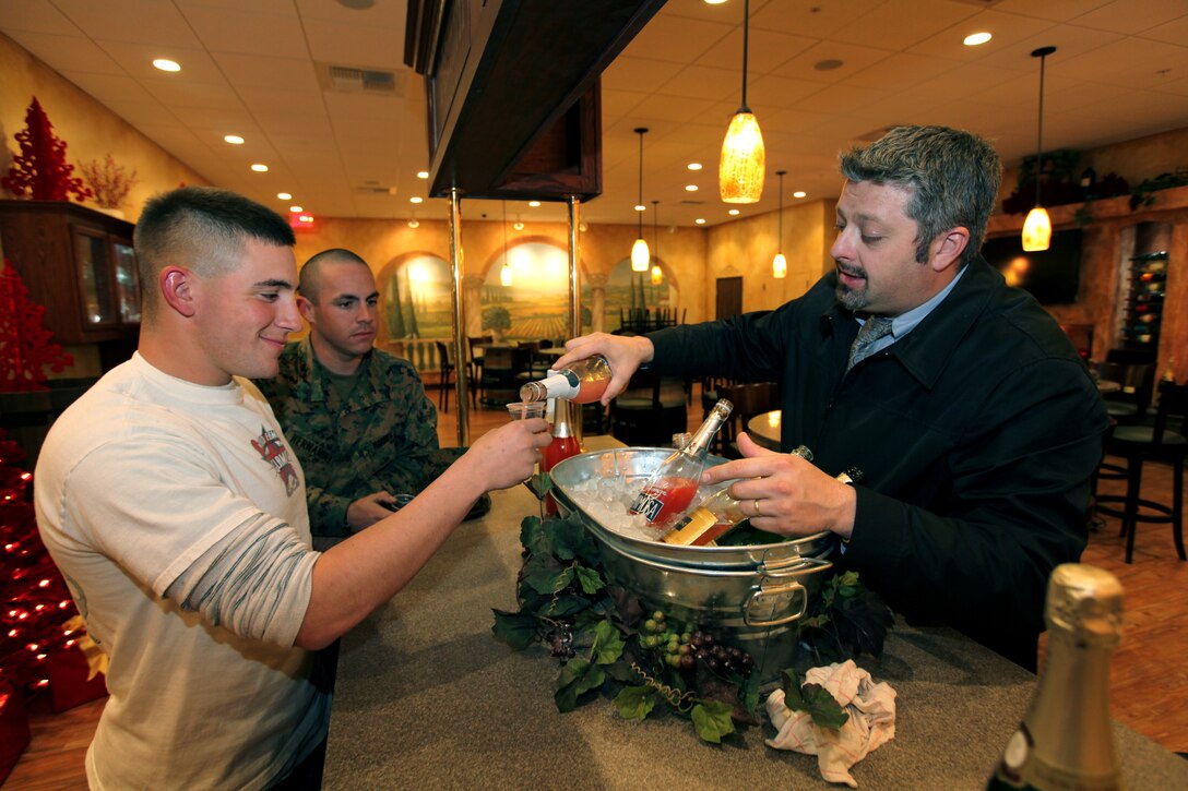 Lance Cpl. Michael Muscara, automotive organizational mechanic, 9th Communications Battalion, I Marine Expeditionary Force, samples various wines offered at a wine tasting event at the Vineyard, Dec. 10. The Vineyard houses wines and spirits from around the world, a walk-in Beer Cave, gifts, accessories, barware, cigar humidors and a wine tasting room, called “La Sala Riunioni”.