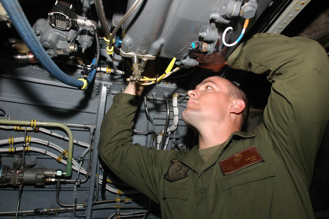 PACIFIC OCEAN (Oct. 2, 2006)--Marine SSgt. Palmer W. Simpson, Selinsgrove, Penn., assigned to the Aviation Combat Element (ACE) Maintenance team of the 15th Marine Expeditionary Unit/Special Operations Capable (MEU/SOC) deployed aboard USS Boxer (LHD 4) checks an SH-53 Helicopter's hydraulic system.  The Maintenance Team performs checks on aircraft to ensure flight readiness and safety.  Boxer is the flag ship for the Boxer Expeditionary Strike Group (BOXESG), operating out of San Diego, Calif.; which is reporting operationally to Commander, Expeditionary Strike Group (ESG) 7/ Task Force (CTF) 76, the Navy's only forward-deployed amphibious task force.  U.S. Navy photo by Mass Communication Specialist Seaman Derek R. Sanchez. (RELEASED)