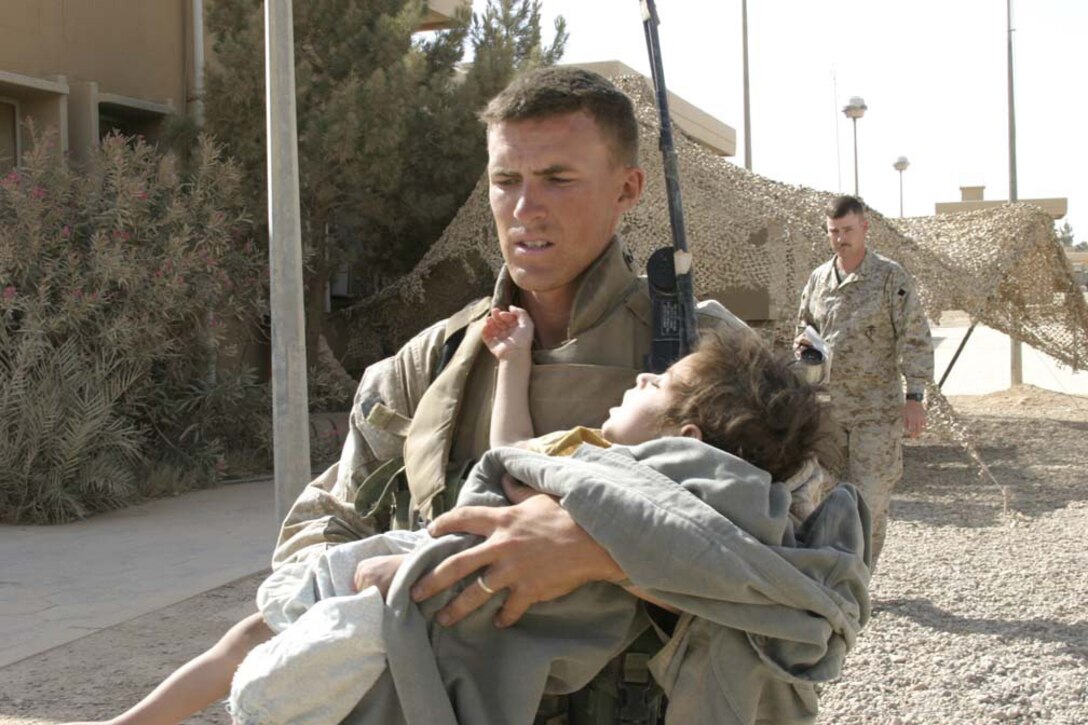 Two Iraqi children are brought into the Regimental Aide Station, Regimental Combat Team 2, Camp Ripper, Al Asad, Iraq, for medical treatment on June 8, 2005. The children were found tied to a cinder block during a house raid in Dhulab, Iraq. Marines attached to 2nd Marine Division, continuously conduct counter-insurgency operations with Iraqi Security Forces (ISF) to isolate and neutralize Anti-Iraqi Forces, support the continued development of ISF, and to support Iraqi reconstruction and democratic elections in order to create a secure environment that enables Iraqi self-reliance and self-governance. (U.S. Marine Corps photo by Lance Cpl. Shane S. Keller) (Released)
