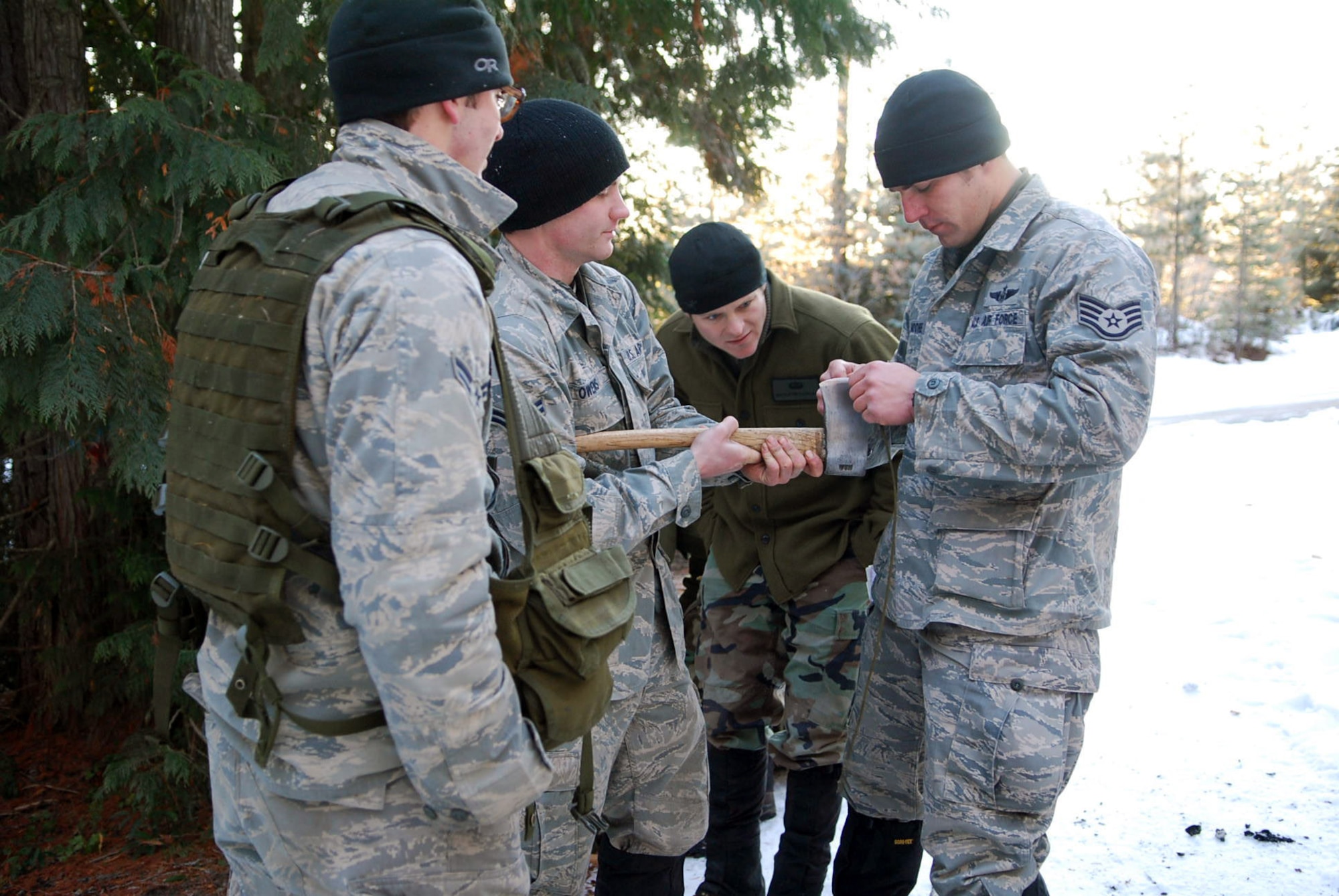 A Survival, Evasion, Resistance and Escape instructor looks on during an inspection prior to a travel day in the Integrated phase of training. (U.S. Air Force photo/Senior Airman Emerald Ralston)
