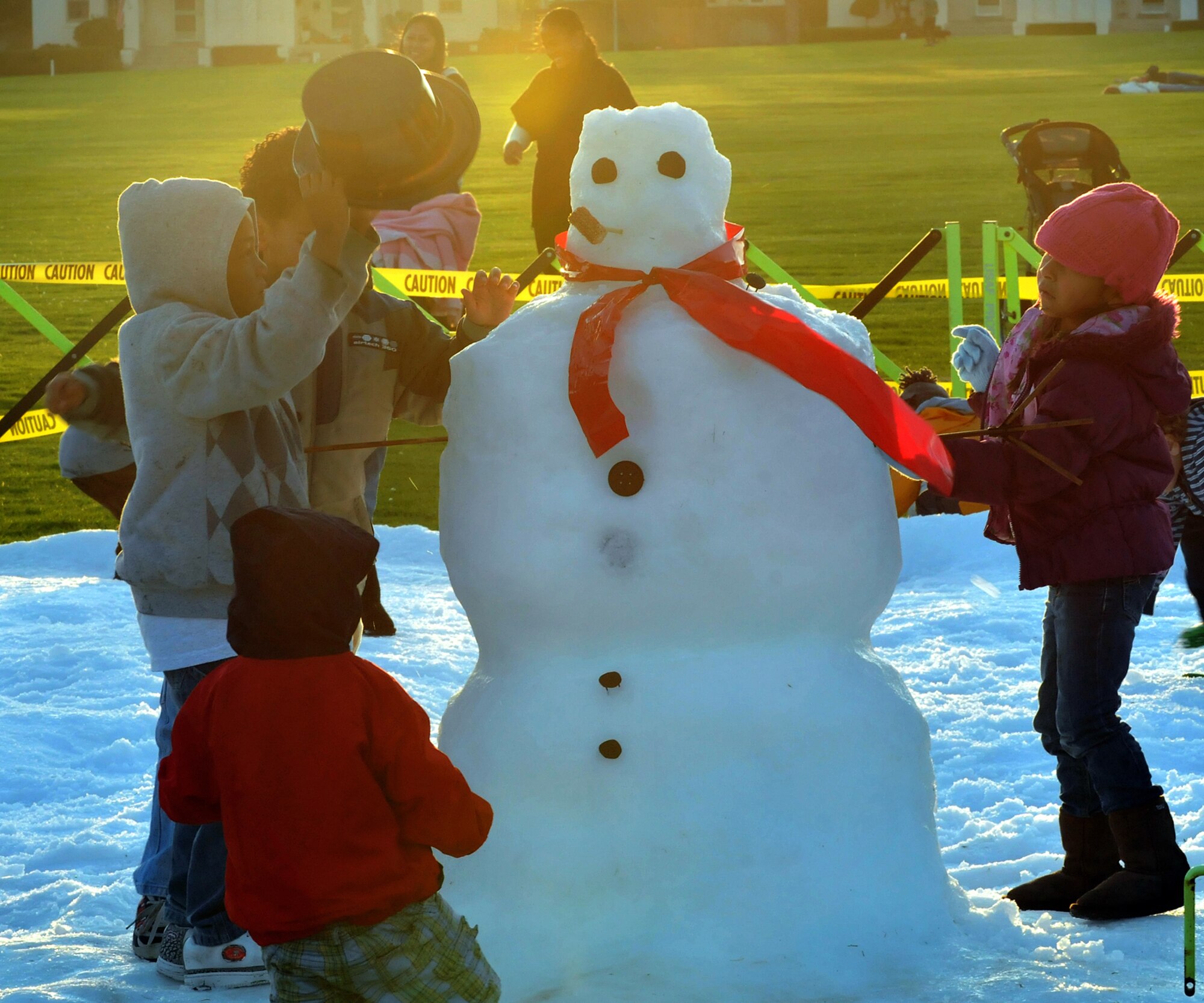 Children play in the snow during the Los Angeles Air Force Base Snow Day held at Fort McArthur, Dec. 4. More than 20 tons of man-made snow covered the children’s play area and was part of the festivities surrounding the annual Tree Lighting Ceremony during the evening.  Other festivities included a visit from Santa, two 50-ft. sled runs and a holiday story reading by Col. Anita Latin, 61st Air Base Wing commander. (Photo by Atiba S. Copeland)