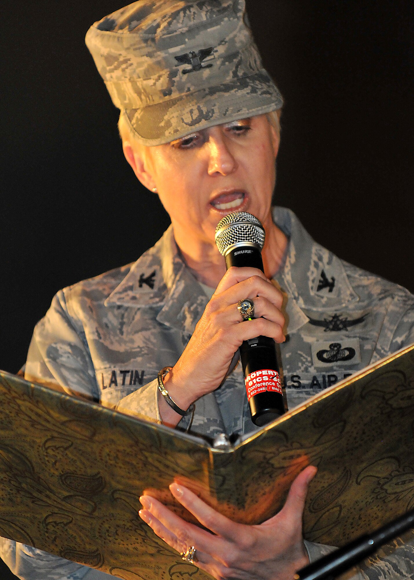 Col. Anita Latin, 61st Air Base Wing commander, reads a holiday story to the spectators during the annual Tree Lighting Ceremony held at Fort McArthur, Dec. 4. Other festivities included a visit from Santa, snow day with children's play area covered with more than 20 tons of man-made snow and two 50-ft. sled runs. (Photo by Atiba S. Copeland)