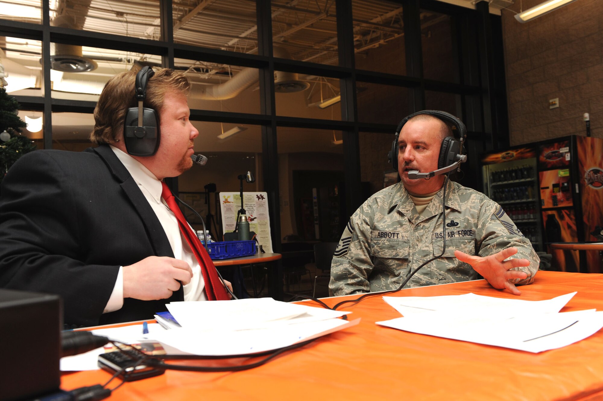 MOUNTAIN HOME AIR FORCE BASE, Idaho – Senior Master Sgt. Dean Abbott, 366th Logistics Readiness Squadron Fuels Management Flight superintendent, talks to Kevin Miller, 580 KIDO AM radio host, during his morning show Dec. 10 at the base fitness center. KIDO broadcasted live from 5-9 a.m. interviewing 16 Airmen and civilians who shared their stories on what it is like to be in the Air Force with radio listeners throughout the  Boise Treasure Valley. (U.S. Air Force photo by Airman 1st Class Debbie Lockhart)