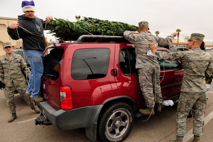 NELLIS AIR FORCE BASE, Nev. -- Airmen volunteering for the Trees for Troops program secure a Christmas tree to a car outside the base chapel Dec. 11. For the fifth consecutive year, The Trees for Troops program, sponsored by the Christmas SPIRIT Foundation and FedEx Corp, provided trees for servicemembers. This year, 15,000 trees from 29 states are expected to be delivered to military bases in the United States and overseas. 
(U.S. Air Force Photo / Staff Sgt. William P. Coleman)


