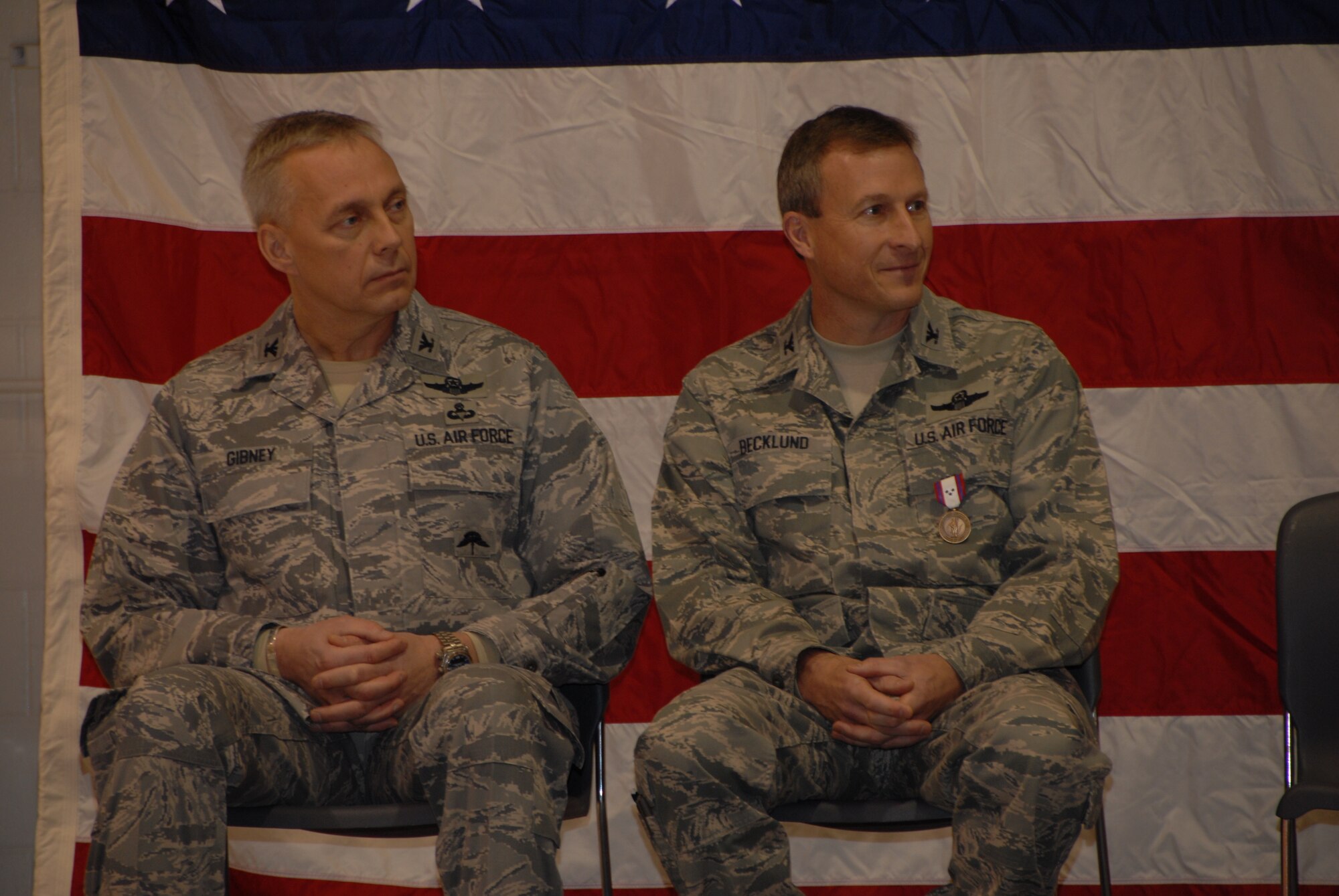 Col. Rick Gibney and Col. Robert Beckund listen to speakers during a Change of Command Ceremony that took place at the North Dakota Air National Guard on Dec. 5th.  Col. Robert Becklund relinquished command of the 119th Wing to Col. Rick Gibney during the ceremony.