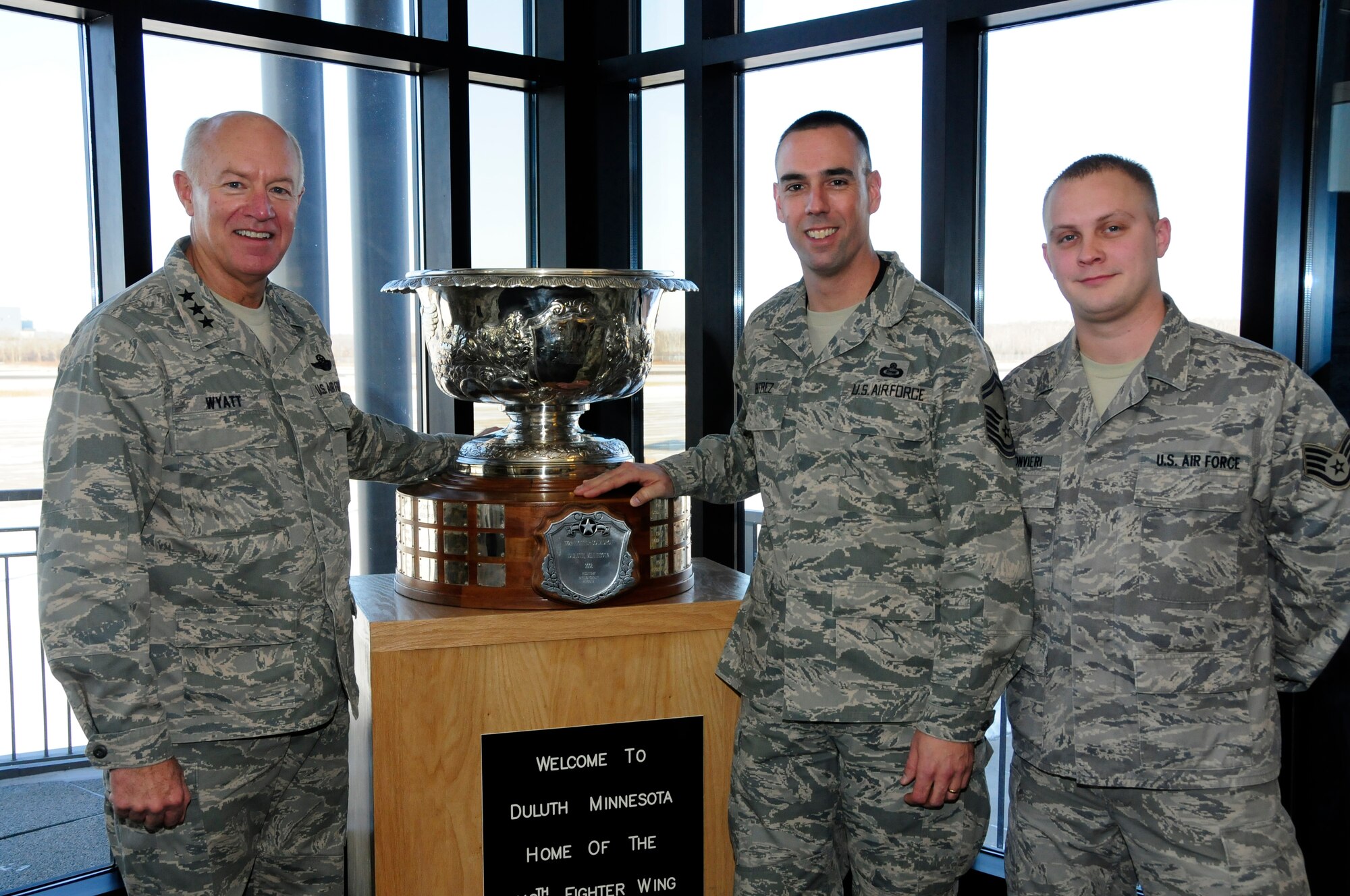 U.S. Air Force Lt. Gen. Harry Wyatt, Director of the Air National Guard, poses next to Senior Master Sgt. Anthony Beatrez and Staff Sgt. Kirk Suonvieri, 148th Intel, and the Raytheon Trophy at the 148th Fighter Wing Air National Guard base in Duluth, Minn. Dec. 11th, 2009.  Beatrez and Suonvieri were both recognized with a coin from Lt. Gen. Wyatt for their dedication to the wing and past deployments. (U.S. Air Force photo by Master Sgt. Jason W. Rolfe)