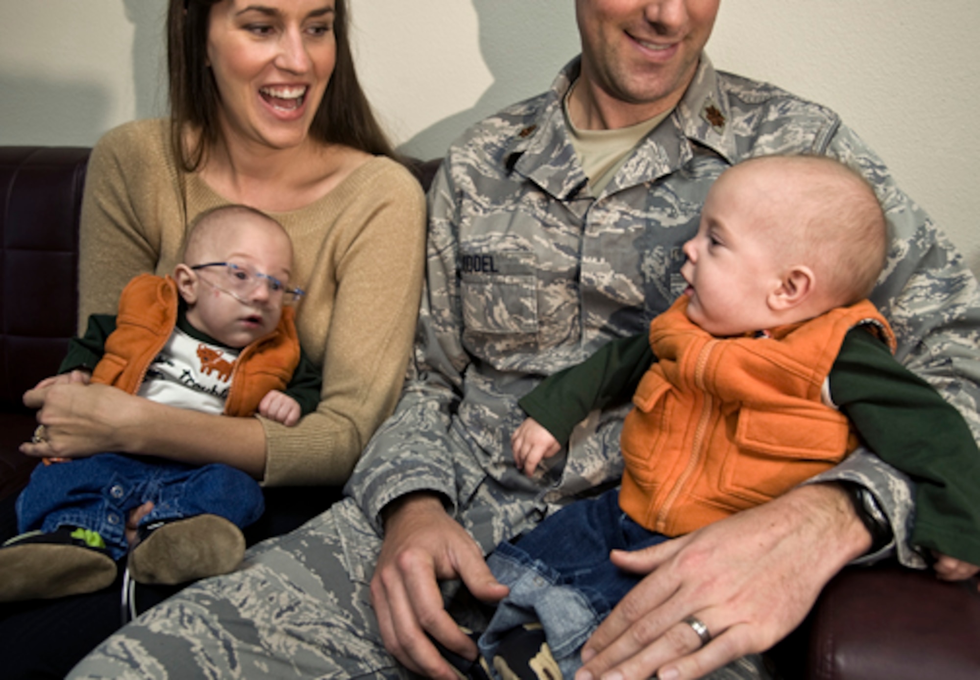 Maj. Cory MIddel and his wife, Laura, share a laugh with their 9-month-old twins, Aaron (left) and James, during an interview about the care they received at the Neonatal Intensive Care Unit at the Wilford Hall Medical Center on Lackland Air Force Base, Texas. Aaron and James were born prematurely and weighed 1 1/2 pounds and 2 1/2 pounds respectively. (U.S. Air Force photo/Staff Sgt. Bennie J. Davis III)