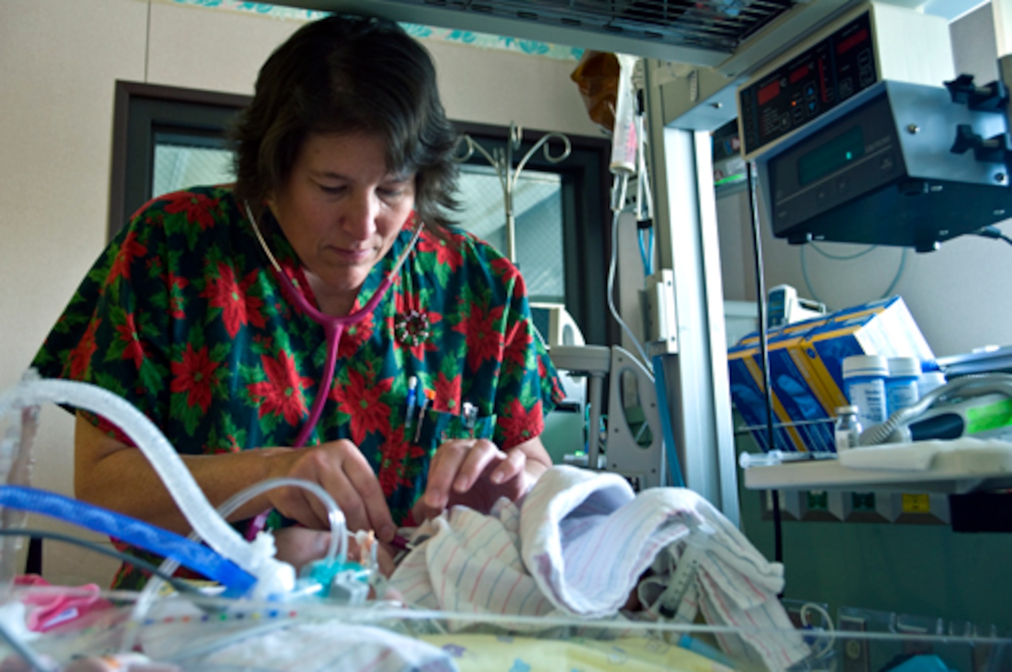 Cheryl Collicott checks the heartbeat of a premature newborn admitted to the Level 3 area of the Neonatal Intensive Care Unit Dec. 10, 2009 at the Wilford Hall Medical Center on Lackland Air Force Base, Texas. Babies cared for in the Level 3 section of the NICU need technological equipment such as ventilators and incubators. Ms. Collicott is a clinical nurse assigned to the NICU. (U.S. Air Force photo/Staff Sgt. Bennie J. Davis III) 