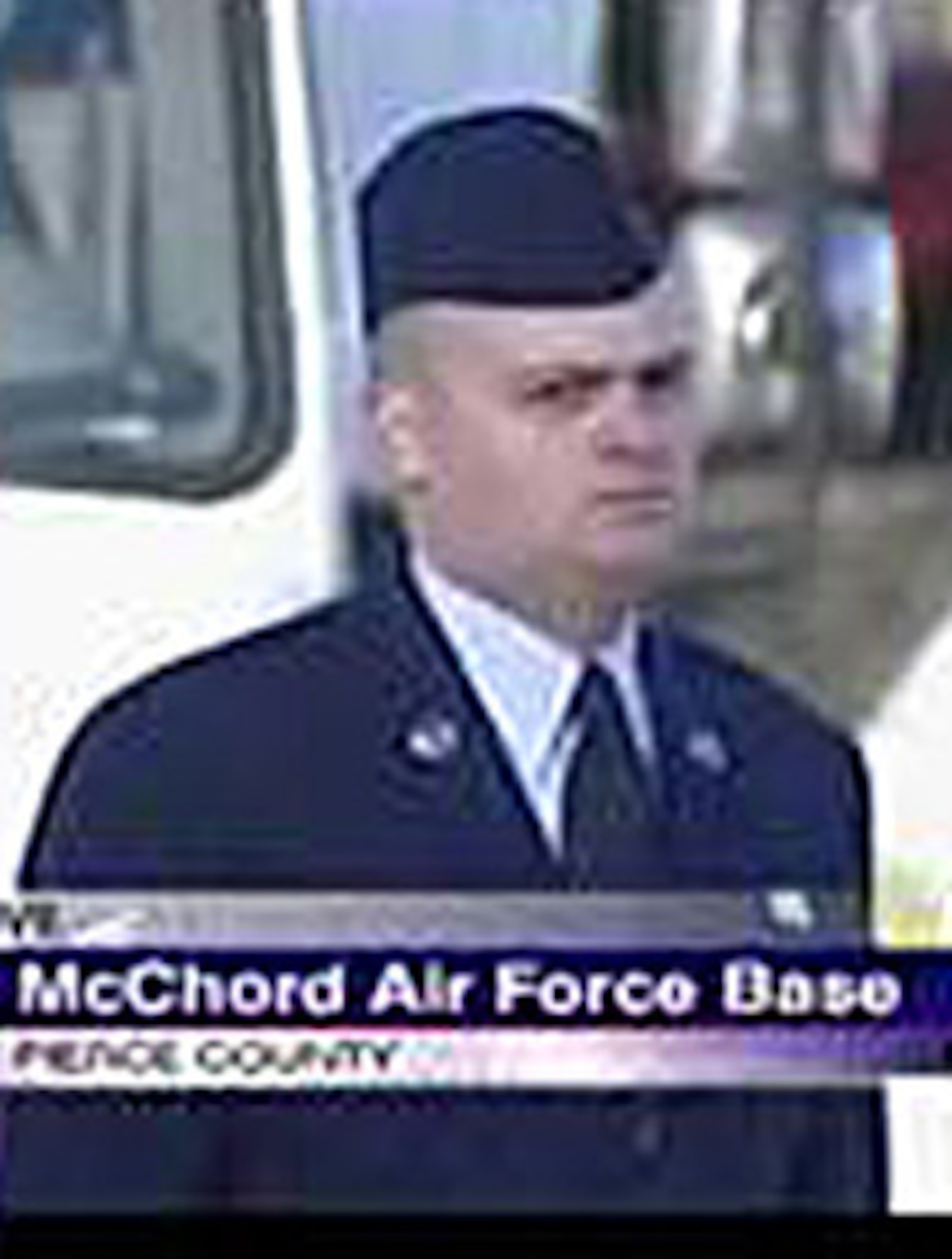 MCCHORD AIR FORCE BASE, Wash., - As show in a KOMO TV 4 video screen shot, Tech. Sgt. Chad Gloor, a Reservist with the 446th Maintenance Squadron here, stands at attention in freezing weather Dec. 8 to show respect during a 2,000-plus vehicle procession in honor of four slain Lakewood, Wash., police officers.  (Courtesy photo/KOMO4)