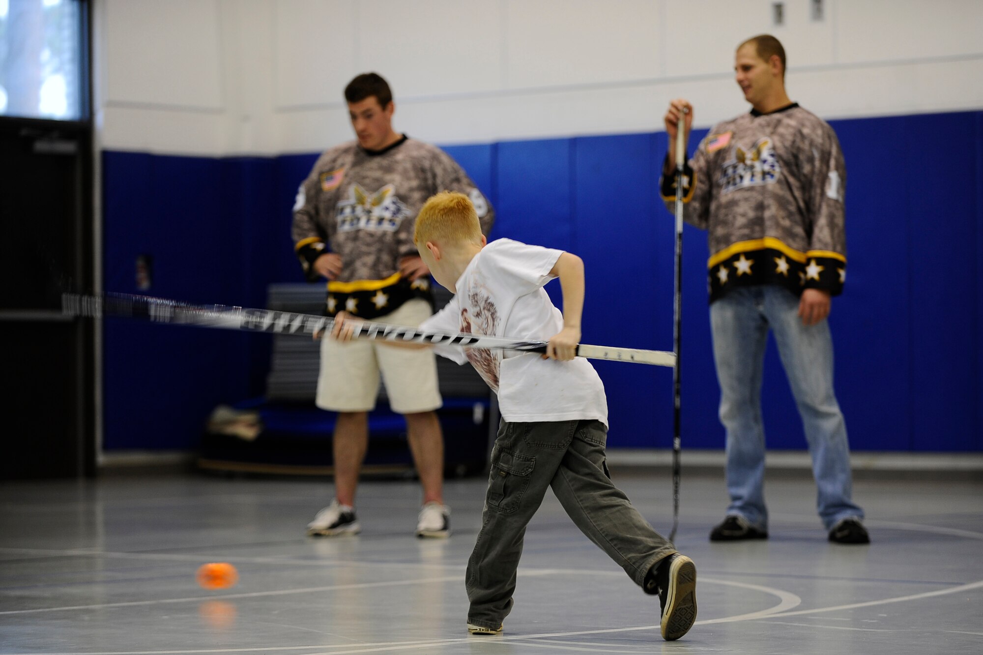 Matthew Collins, eight, scores a goal during the Pensacola Ice Flyers’ visit to the Hurlburt Field youth center Dec. 9. The Ice Flyers, a Southern Professional Hockey League expansion team, were also here to promote interest in the sport among those in attendance. (Air Force photo by Senior Airman Julianne Showalter)