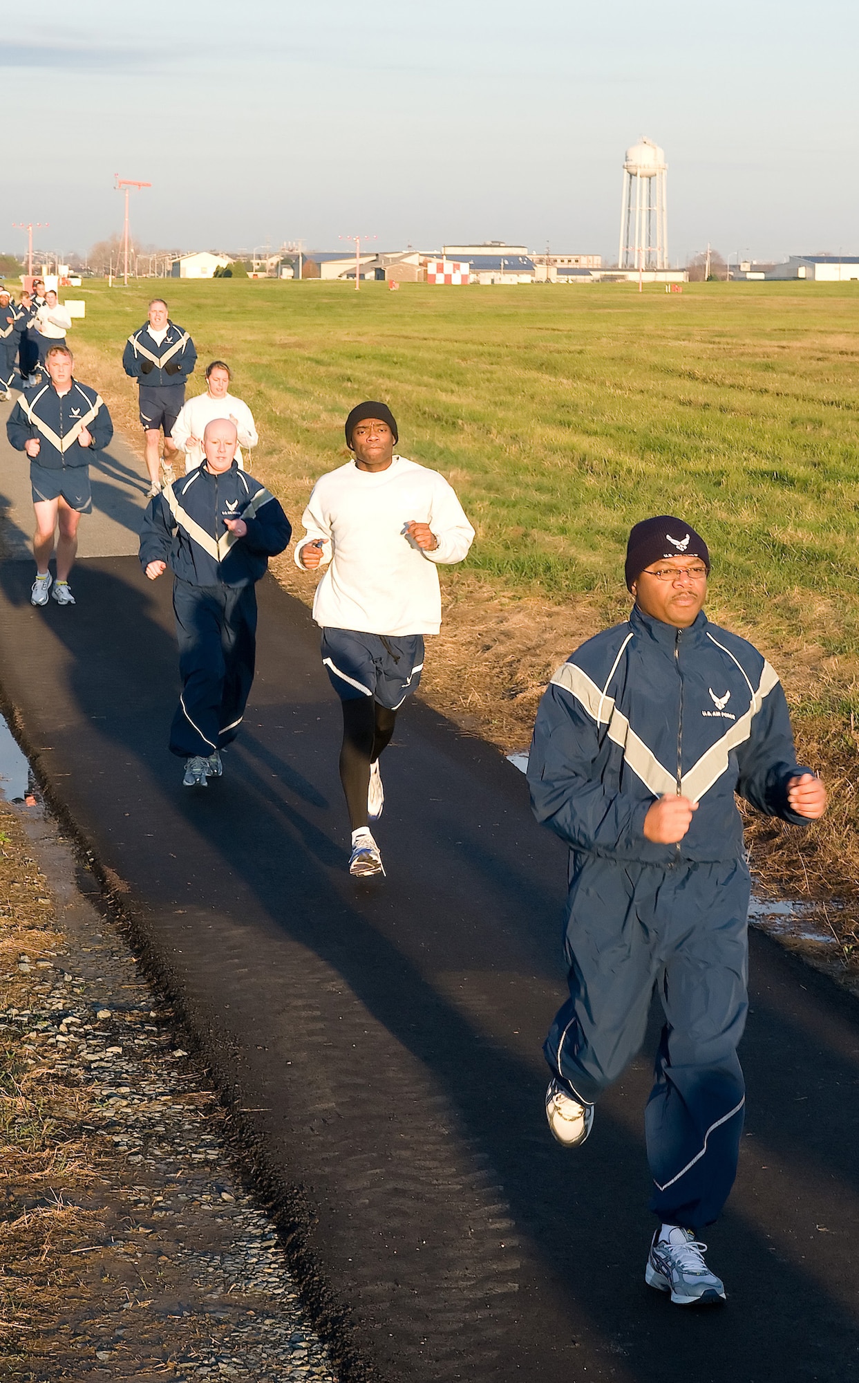 Airmen from the 436th Medical Group run along Perimeter Road as part of Wingman Day Dec. 4. Wingman Day is a day set aside to build camaraderie, help Airmen embrace the culture of 'Airmen taking care of Airmen,' and a day to step back from daily work to see the big picture - the Air Force family and the mission. (U.S. Air Force photo/ Jason Minto)
