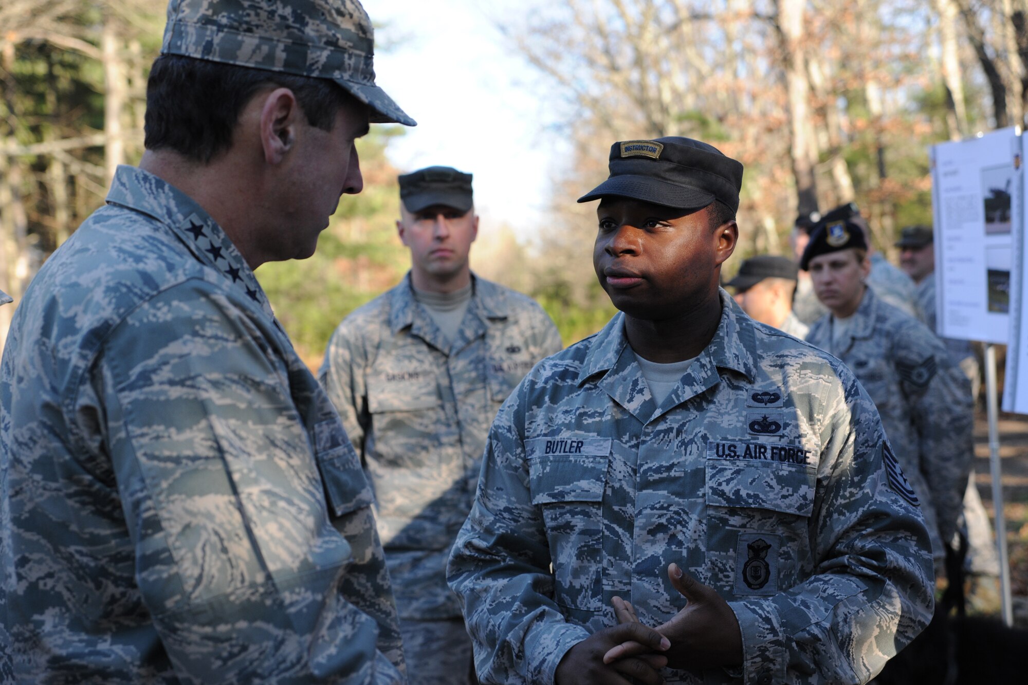 Tech. Sgt. Shaylin Butler, 421st Combat Training Squadron instructor, describes the specialized training security forces members get in the Tactical Security Element to Gen. Raymond Johns Jr., Air Mobility Command commander, on a Fort Dix range during a visit December 3 to the U.S. Air Force Expeditionary Center on Joint Base McGuire-Dix-Lakehurst.  (U.S. Air Force Photo/Staff Sgt. Nathan G. Bevier) 