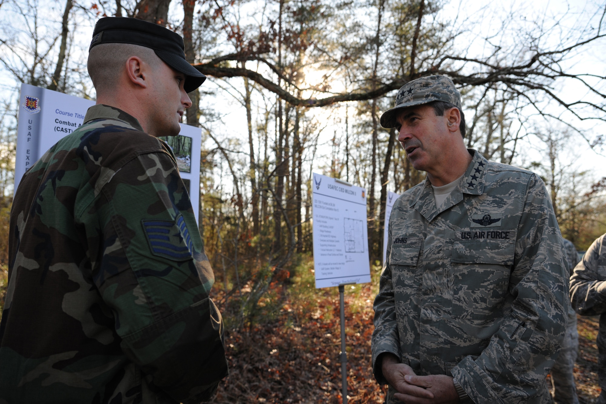 Tech. Sgt. Jonathan Tourville, 421st Combat Training Squadron instructor, gives an overview of the Combat Airman Skills Training Course to Gen. Raymond Johns Jr., Air Mobility Command commander, on a Fort Dix range during a visit December 3 to the U.S. Air Force Expeditionary Center on Joint Base McGuire-Dix-Lakehurst.  (U.S. Air Force Photo/Staff Sgt. Nathan G. Bevier) 