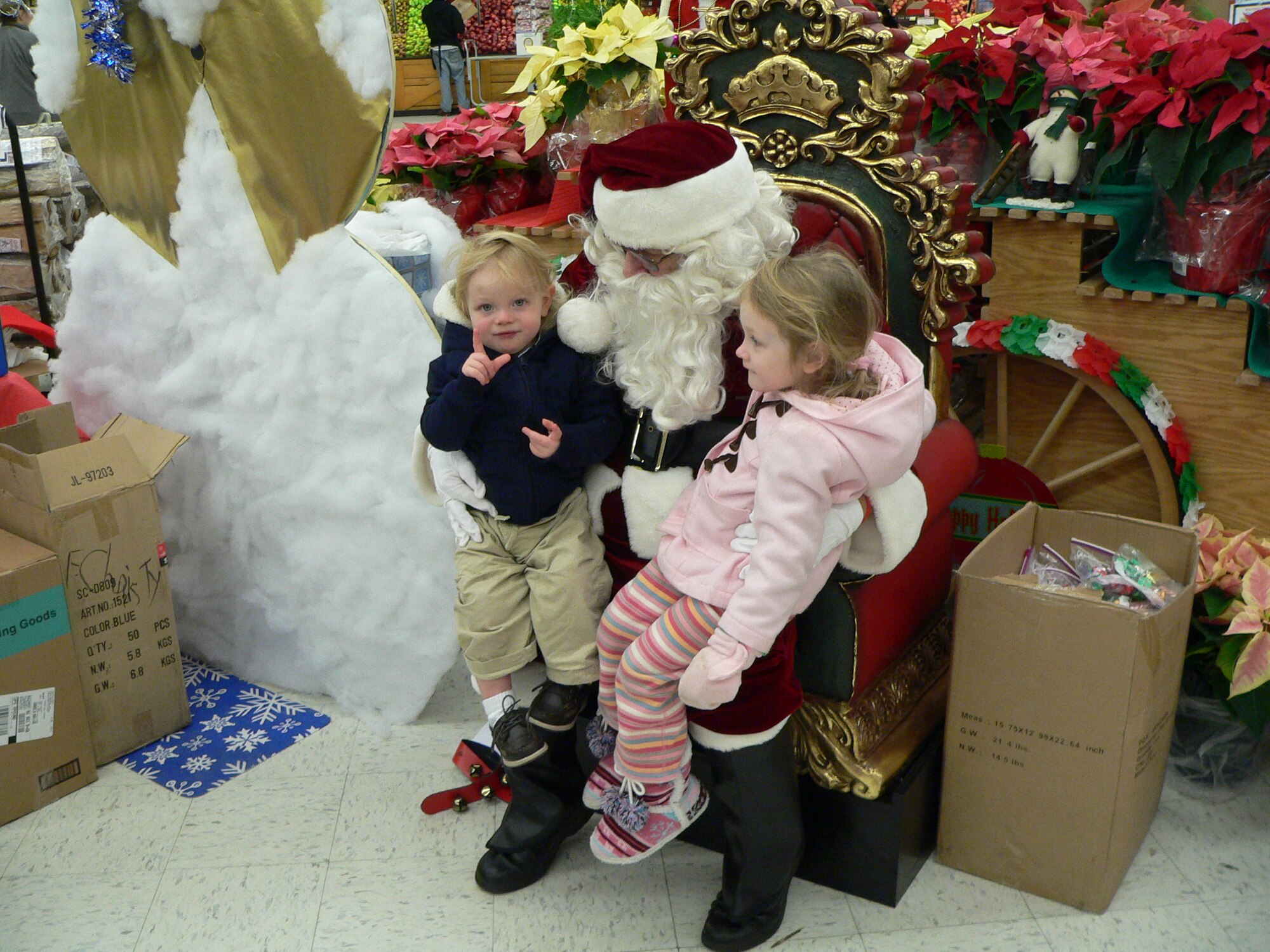 Samantha Eichman, 5, tells Santa Claus what she wants for Christmas. Santa visited Joint Base McGuire-Dix-Lakehurst children at the commissary Dec. 11. (U.S. Air Force photo/Stephen Snyder).