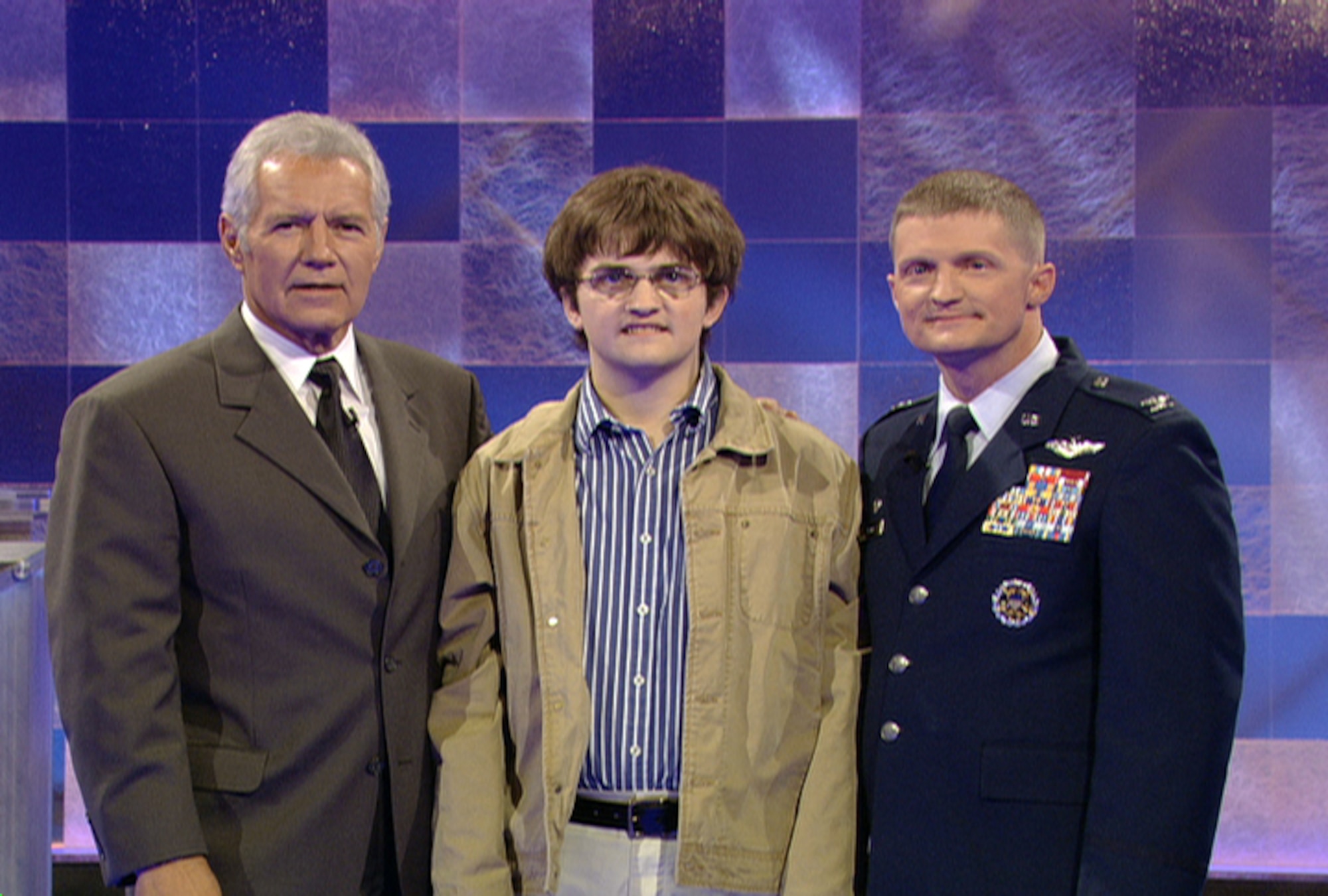 Col. Dave Belote (right) and his son, Drew (center) pose for a photo with Alex Trebek, the host of "Jeopardy!" while participating on an episode of the show Dec. 9, 2009, in Los Angeles. Colonel Belote is the 99th Air Base Wing commander at Nellis Air Force Base, Nev. (Courtesy photo)