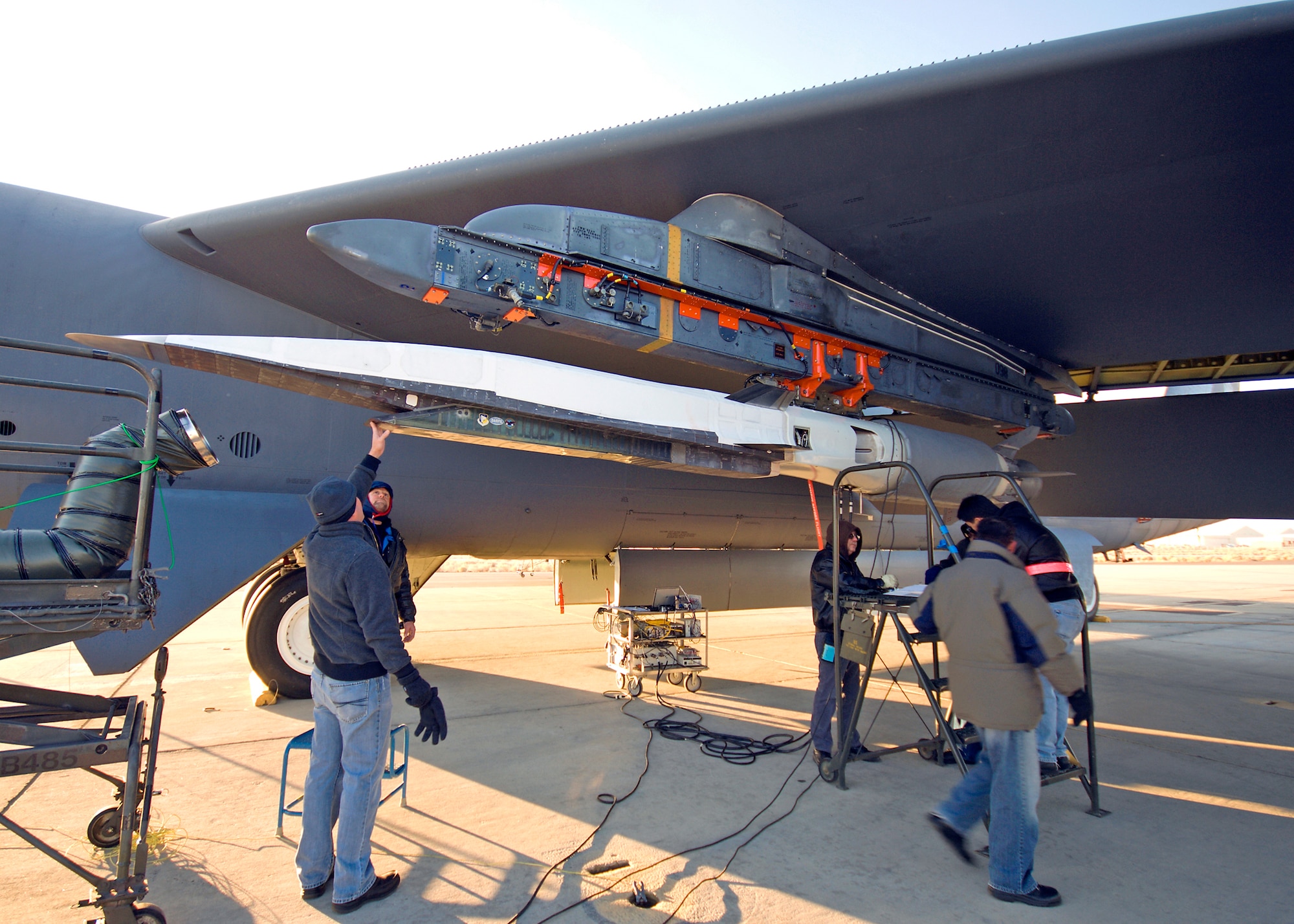 Crewmembers and program officials prepare the X-51A WaveRider for a captive carry flight under an Air Force Flight Test Center B-52H Stratofortress Dec. 9, 2009, at Edwards Air Force Base, Calif. The captive carry mission is part of preparations being made prior to the X-51's first powered hypersonic flight in early 2010. (U.S. Air Force photo/Mike Cassidy)