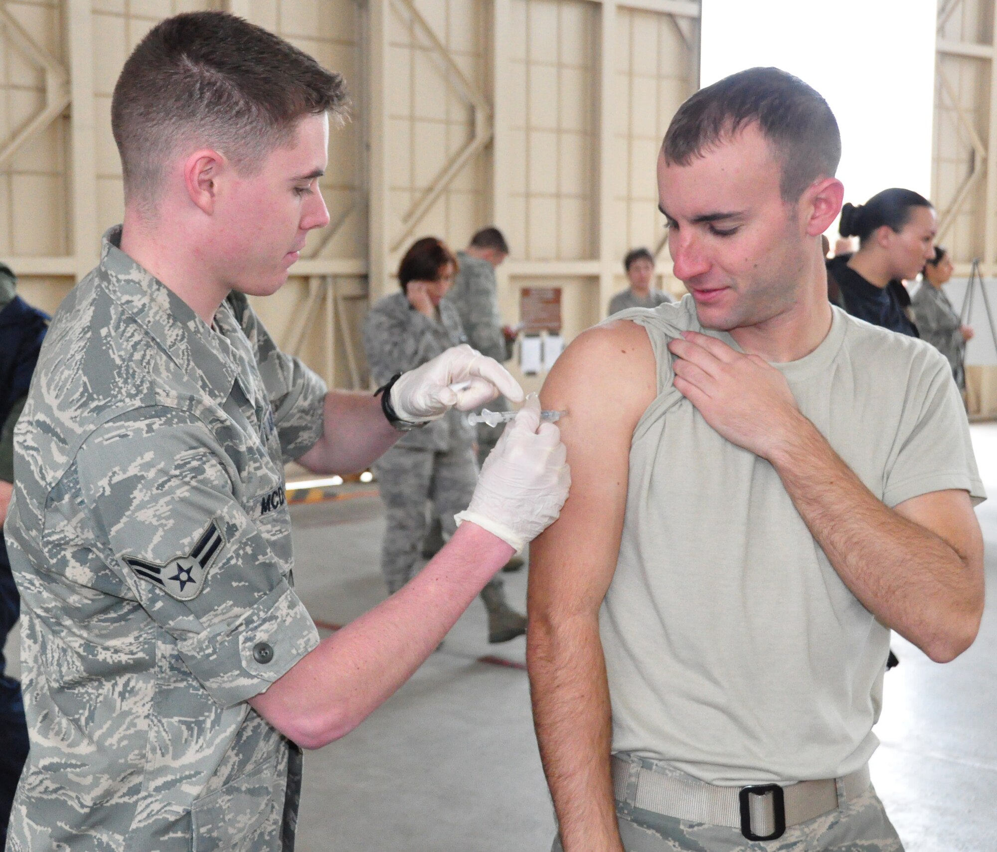Airman 1st Class Matthew McDowell, 325th Medical Group Aerospace Medical Technician, administered the H1N1 Vaccination to Airman 1st Class Brian DiCarlo, 43rd Aircraft Maintenance Unit F-22 Crew Chief, Dec. 11 at Hangar 3. Tyndall Air Force base is projected to have all active duty members vaccinated shortly after the holiday season. (U.S. Air Force photo by Airman 1st Class Rachelle Elsea)