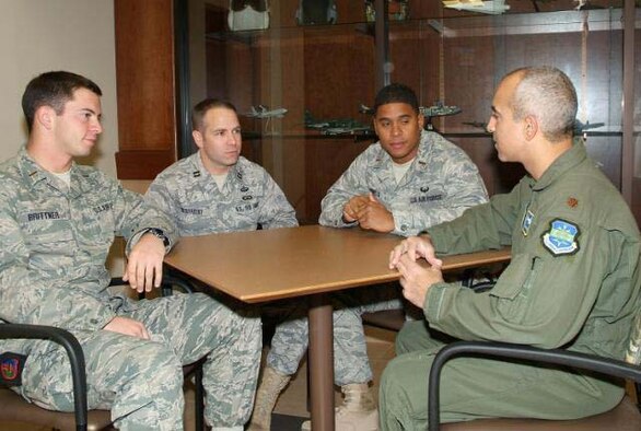 HURLBURT FIELD, Fla. -- Air liaison officers Second Lt. Michael Brittner (from left), Capt. Matthew McMurtry and 2nd Lt. Brandon Pinto, talk with Maj. Steven Glendenning, 505th Training Squadron manager of the Joint Air Operations Command and Control Course on Dec. 11. The ALOs are three of 15 in the first class of career ALOs and were attending the JAOC2C as part of their training requirements for the new 13L career field. They graduated Dec. 17. (Air Force photo by Keith Keel)

