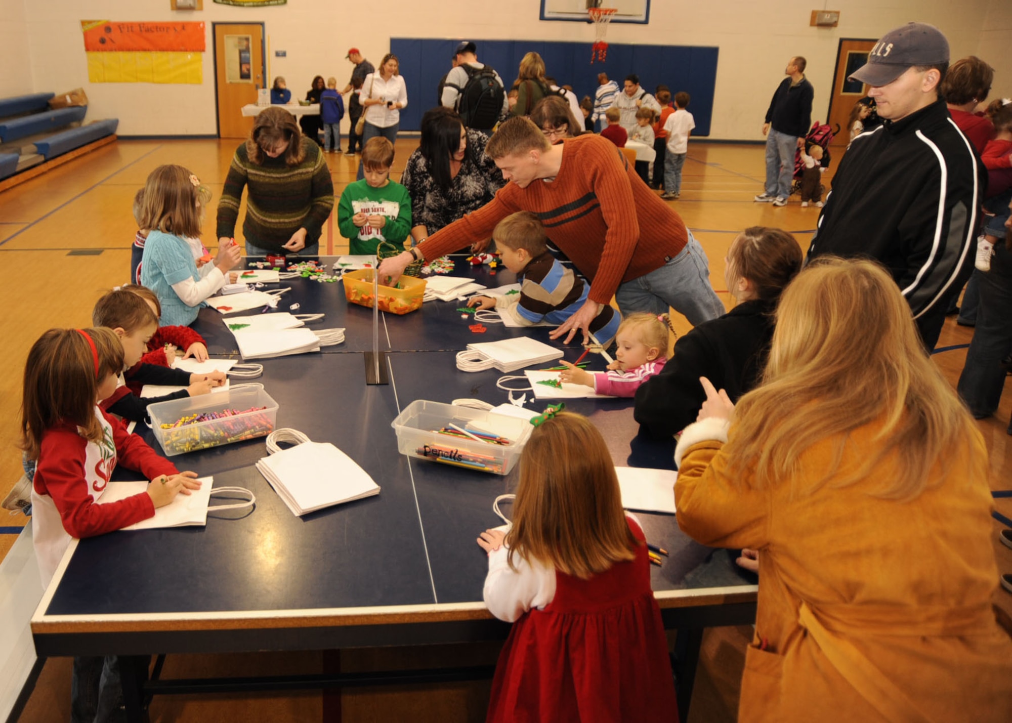 Children decorate gift bags during a Breakfast with Santa event held at the Youth Center of Scott AFB, Ill., Dec. 5th. The children played basketball, Christmas Bingo and pin the nose on Rudolph. (U.S. Air Force photo by Airman 1st Class Tristin English)