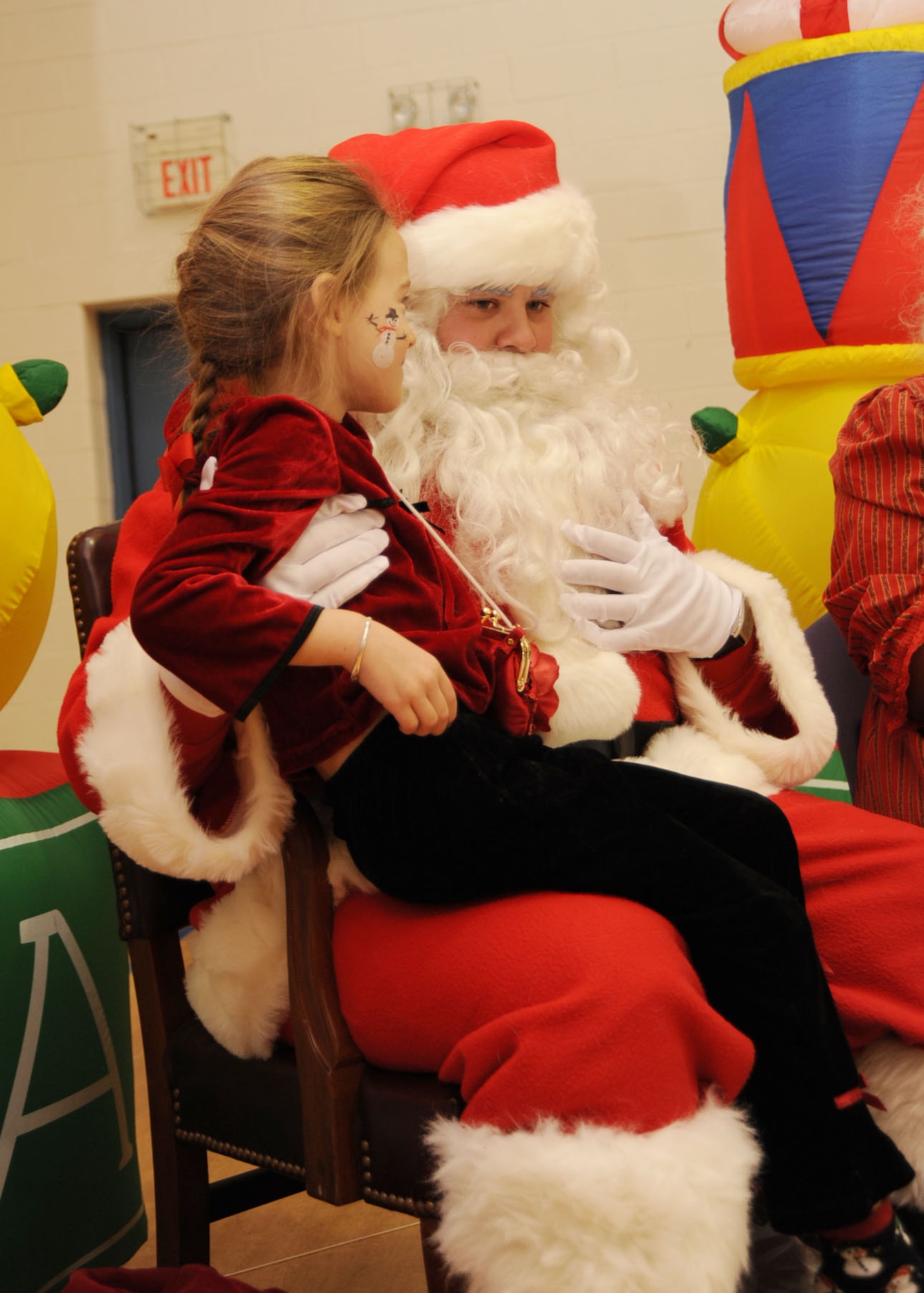 Five year old Lauren Adams sits on Santa’s lap as she tells him what she wants for Christmas during a Breakfast with Santa event held at the Youth Center of Scott AFB, Ill., Dec. 5th. The event brought kids together to enjoy face painting, decorating gift bags and dressing up as Santa. (U.S. Air Force photo by Airman 1st Class Tristin English)