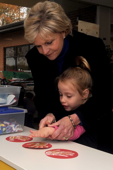 North Carolina governor Bev Perdue helps Kaedence Mason, 4 years old, find which hand art is hers during a base tour of the child development center on Seymour Johnson Air Force Base, N.C., Dec. 11, 2009. Governor Perdue is North Carolina's 73rd governor and is also the state's first female governor. Kaedence is the daughter of Senior Airman Ryan Mason, 4th Aircraft Maintenance Squadron supply technician.  (U.S. Air Force photo/Staff Sgt. Courtney Richardson)