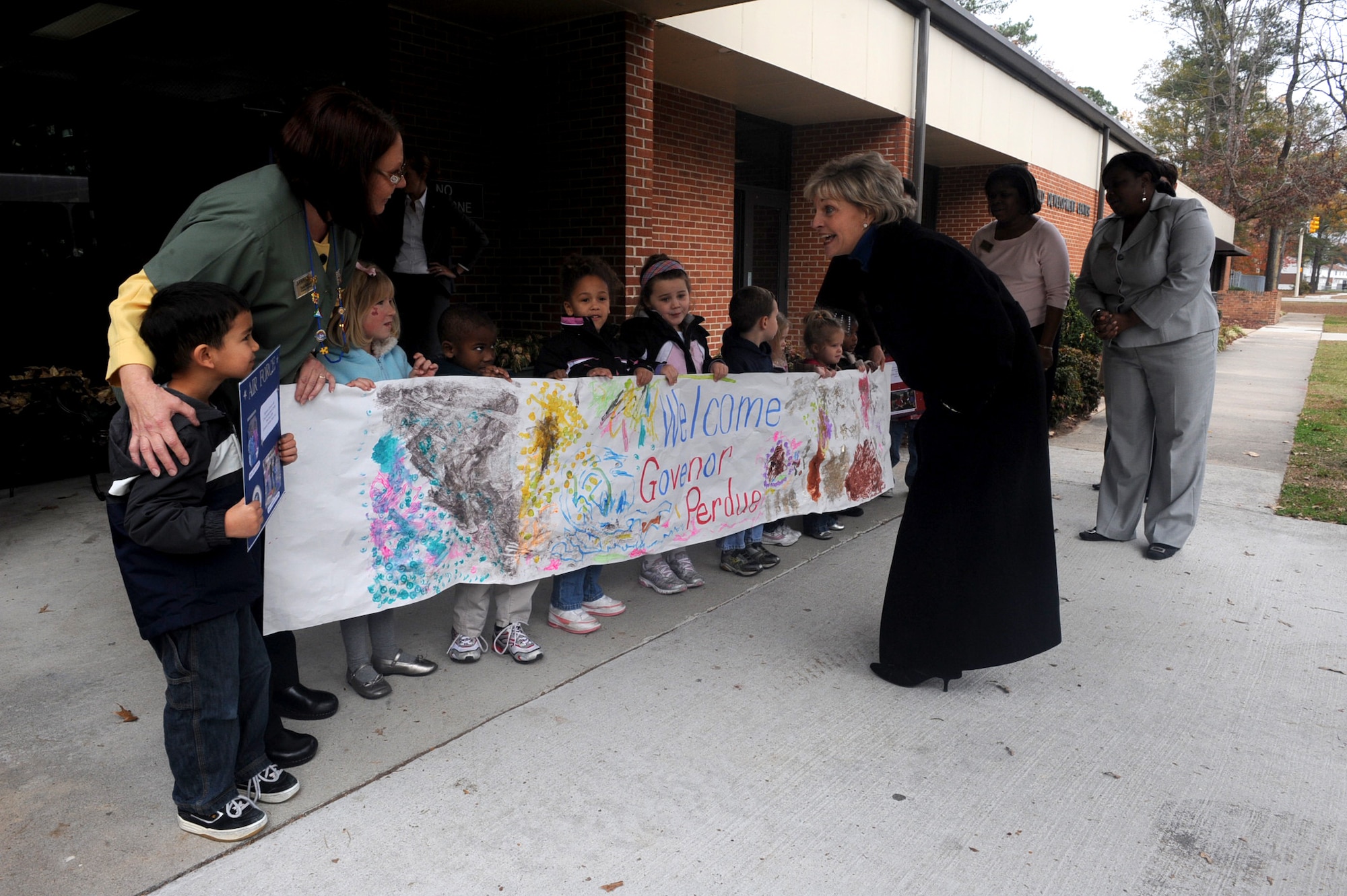 North Carolina governor Bev Perdue thanks children welcoming her into the child development center during a base tour on Seymour Johnson Air Force Base, N.C., Dec. 11, 2009.  Governor Perdue was presented two handmade certificates from the children, thanking her for visiting them. (U.S. Air Force photo/Staff Sgt. Courtney Richardson)