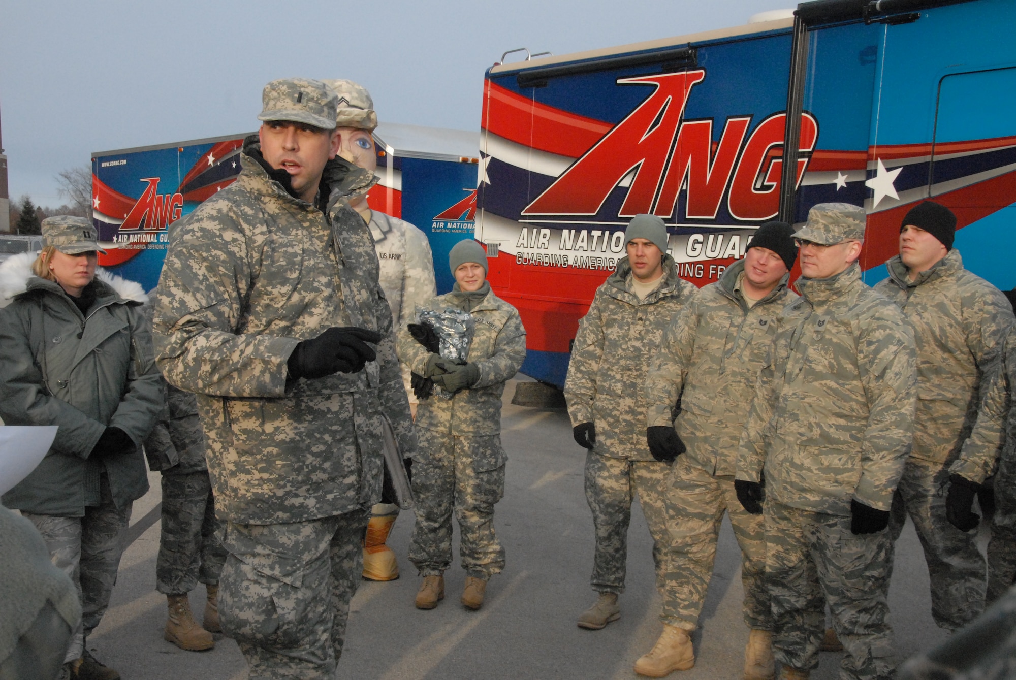 Army First Lt. Johnny Simmons, marketing officer with the Wisconsin Air National Guard recruiting command, briefs recruiters and other National Guard members as they prepare to greet Packer fans at a recent display at Lambeau Field celebrating military families and the National Guard's 373rd birthday.  (U.S. Air Force Photo by Tech. Sgt. Don Nelson)