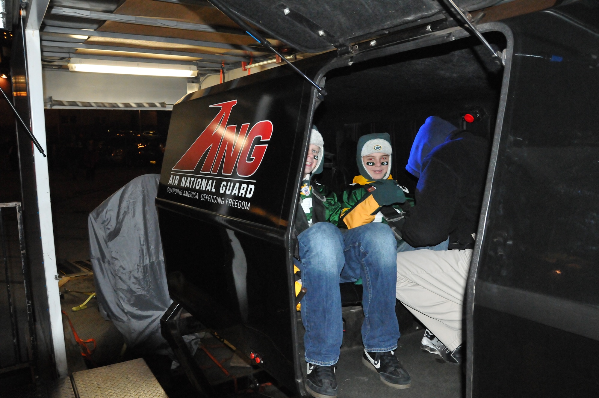 Brandon Kukal, 12 and Andrew Christensen, 11 of White Cloud, Michgan, get strapped into the Air National Guard simulator which moves 360 degrees allows the occupants to experience a 2-minute air-to-air combat scenario.  (U.S. Air Force Photo by Tech. Sgt. Don Nelson)