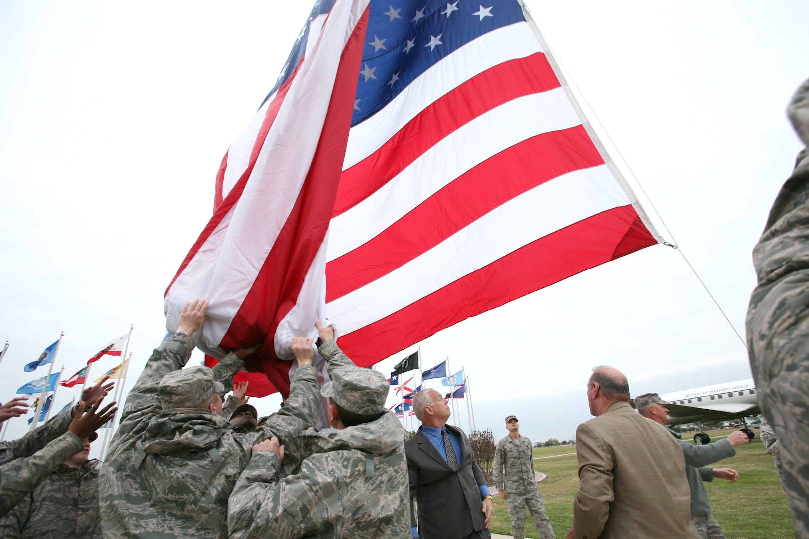 The Lackland garrison flag is raised for the first time Dec. 3 as members of the base honor guard keep it from touching the ground. The garrison flag is an oversized flag, 20 feet by 38 feet, which will be flown on Fridays, holidays and other special occasions. (U.S. Air Force photo/Robbin Cresswell) 