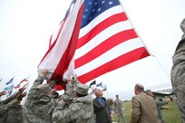 The Lackland garrison flag is raised for the first time Dec. 3 as members of the base honor guard keep it from touching the ground. The garrison flag is an oversized flag, 20 feet by 38 feet, which will be flown on Fridays, holidays and other special occasions. (U.S. Air Force photo/Robbin Cresswell) 