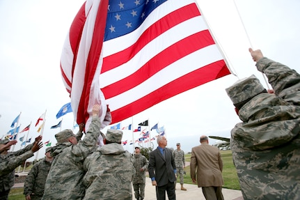 The Lackland garrison flag is raised for the first time Dec. 3 as members of the base honor guard keep it from touching the ground. The garrison flag is an oversized flag, 20 feet by 38 feet, which will be flown on Fridays, holidays and other special occasions. (U.S. Air Force photo/Robbin Cresswell) 