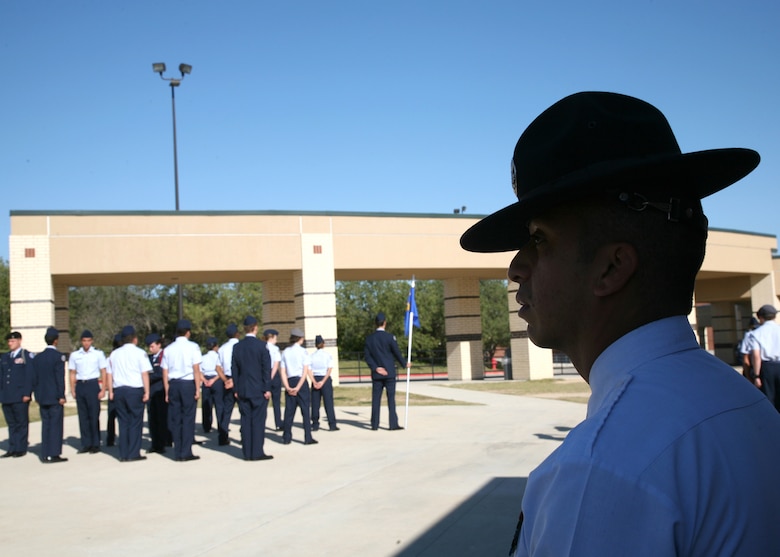 Staff Sgt. Joseph Flores, 323rd Training Squadron, observes a Stevens High School Junior ROTC drill event Nov. 18. Sergeant Flores recently shadowed recruiters in San Antonio for a week to better understand the recruiting process. (U.S. Air Force photo/Robbin Cresswell)