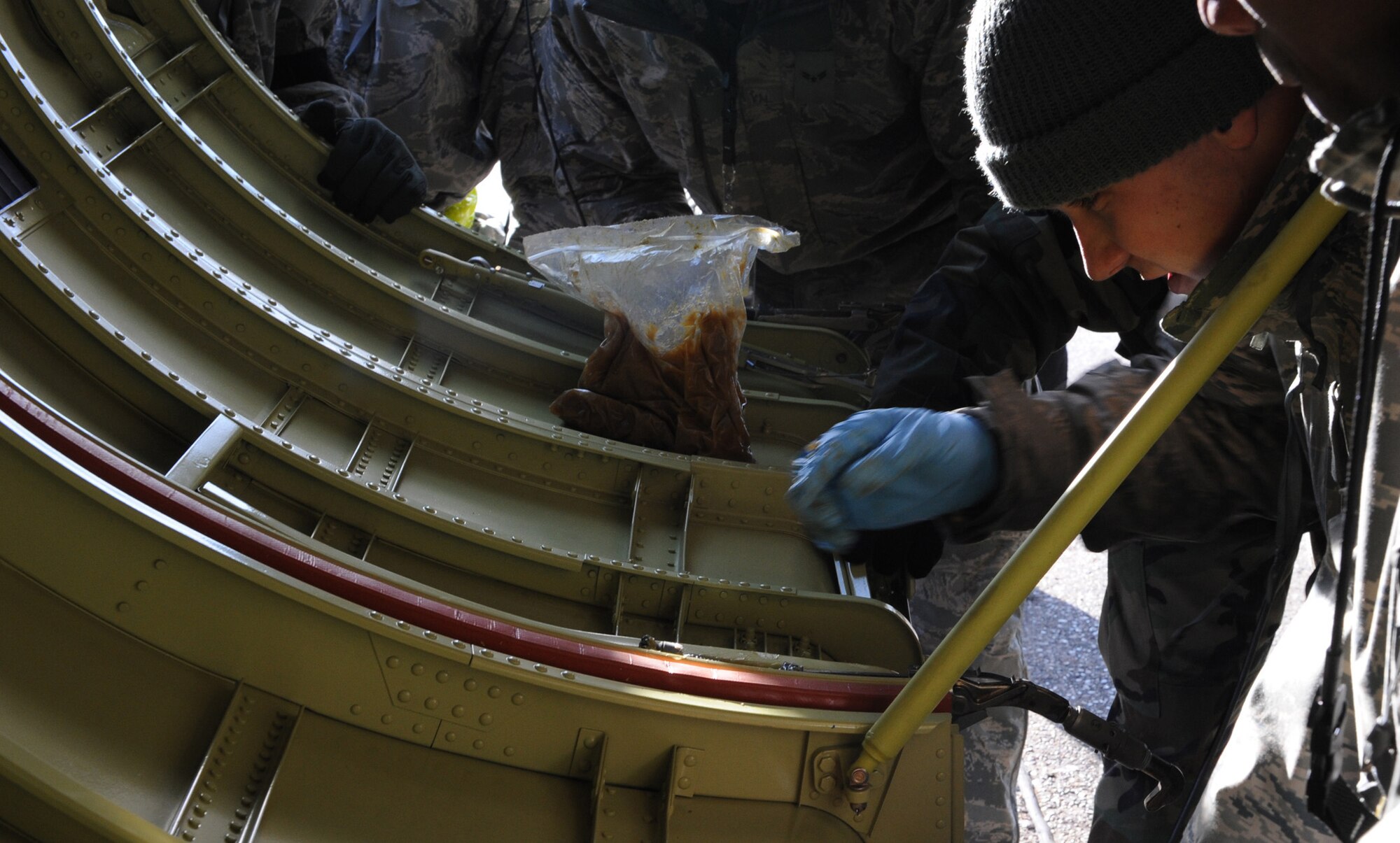 Airman Jake Korthas, 2d Aircraft Maintenance Squadron, applies grease to the locks of a new B-52 engine cowling during a conventional operational readiness exercise at Barksdale. Airmen generated several aircraft to highlight their capability to support global contingency operations. (U.S. Air Force photo by Tech. Sgt. Mike Andriacco) (RELEASED)