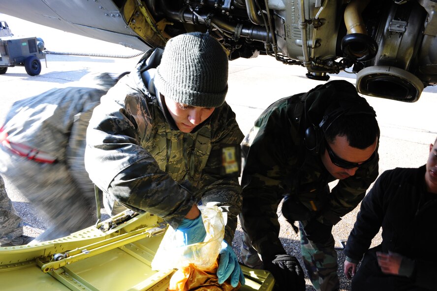 Airman Jake Korthas, 2d Aircraft Maintenance Squadron, applies grease to the locks of a new B-52 engine cowling during a conventional operational readiness exercise at Barksdale. Airmen generated several aircraft to highlight their capability to support global contingency operations. (U.S. Air Force photo by Tech. Sgt. Mike Andriacco) (RELEASED)